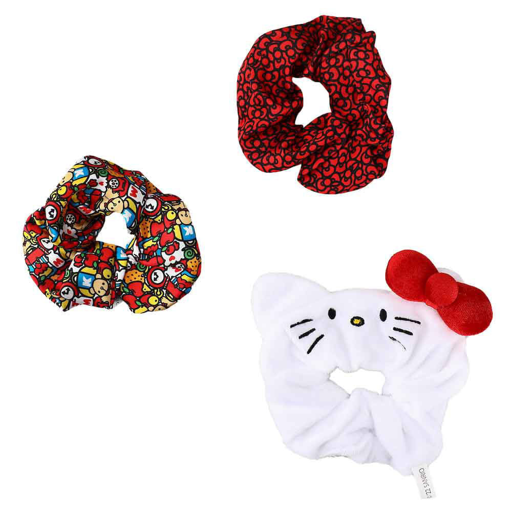A close-up of the Hello Kitty face-shaped scrunchie with a red bow, highlighting the adorable details.
