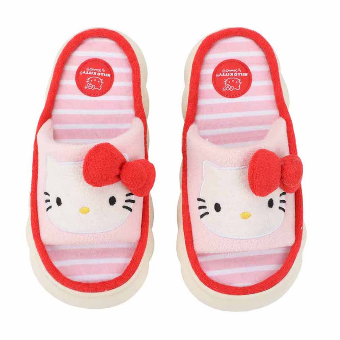 A woman wearing Hello Kitty loungewear slides, lounging on a couch