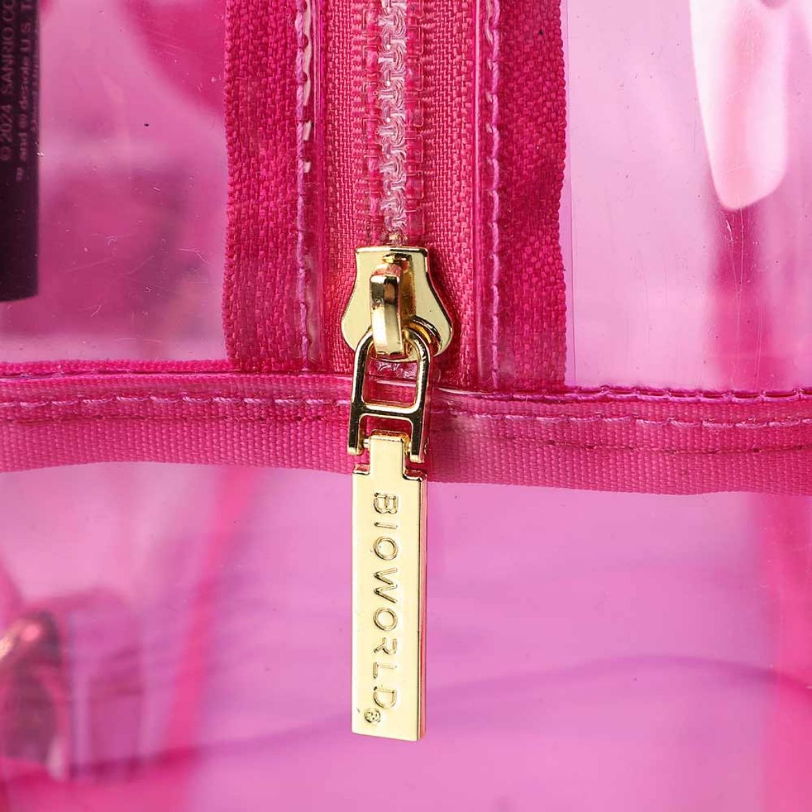 Close-up of Hello Kitty plush detail on the clear PVC backpack.