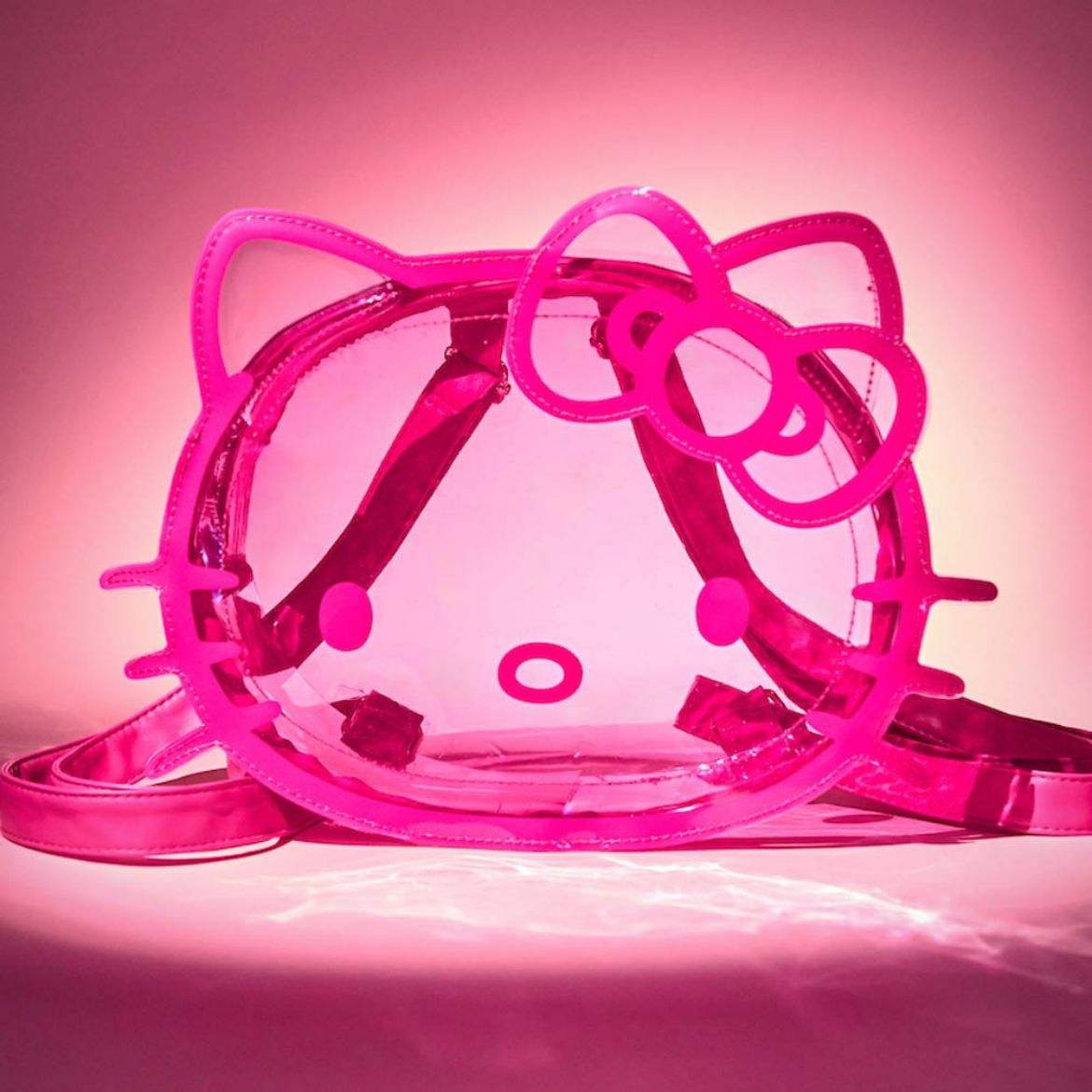 Side angle showing adjustable straps and zipper closure of the pink mini backpack.