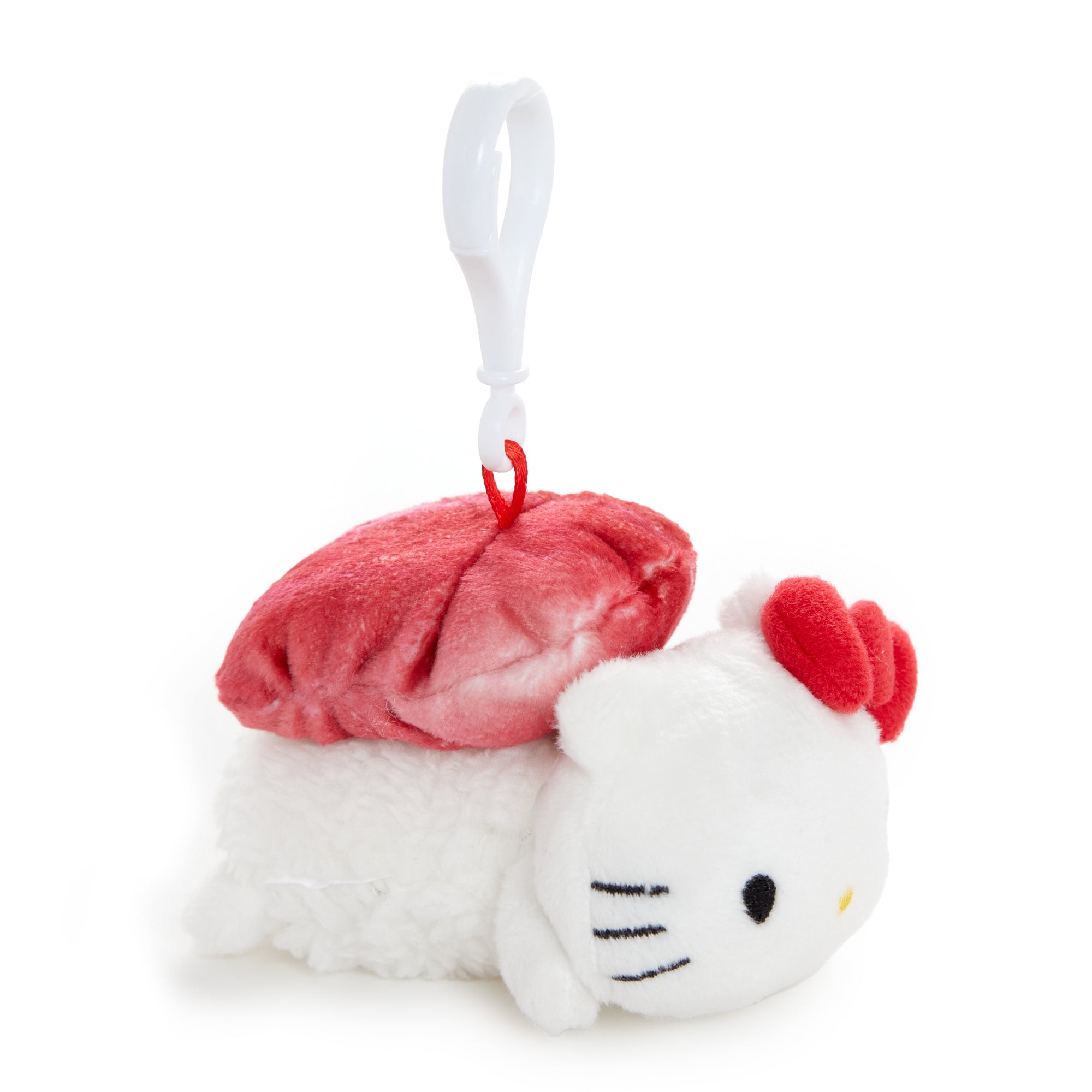 Trio of Sanrio mascot clips arranged on a notebook for styling inspiration