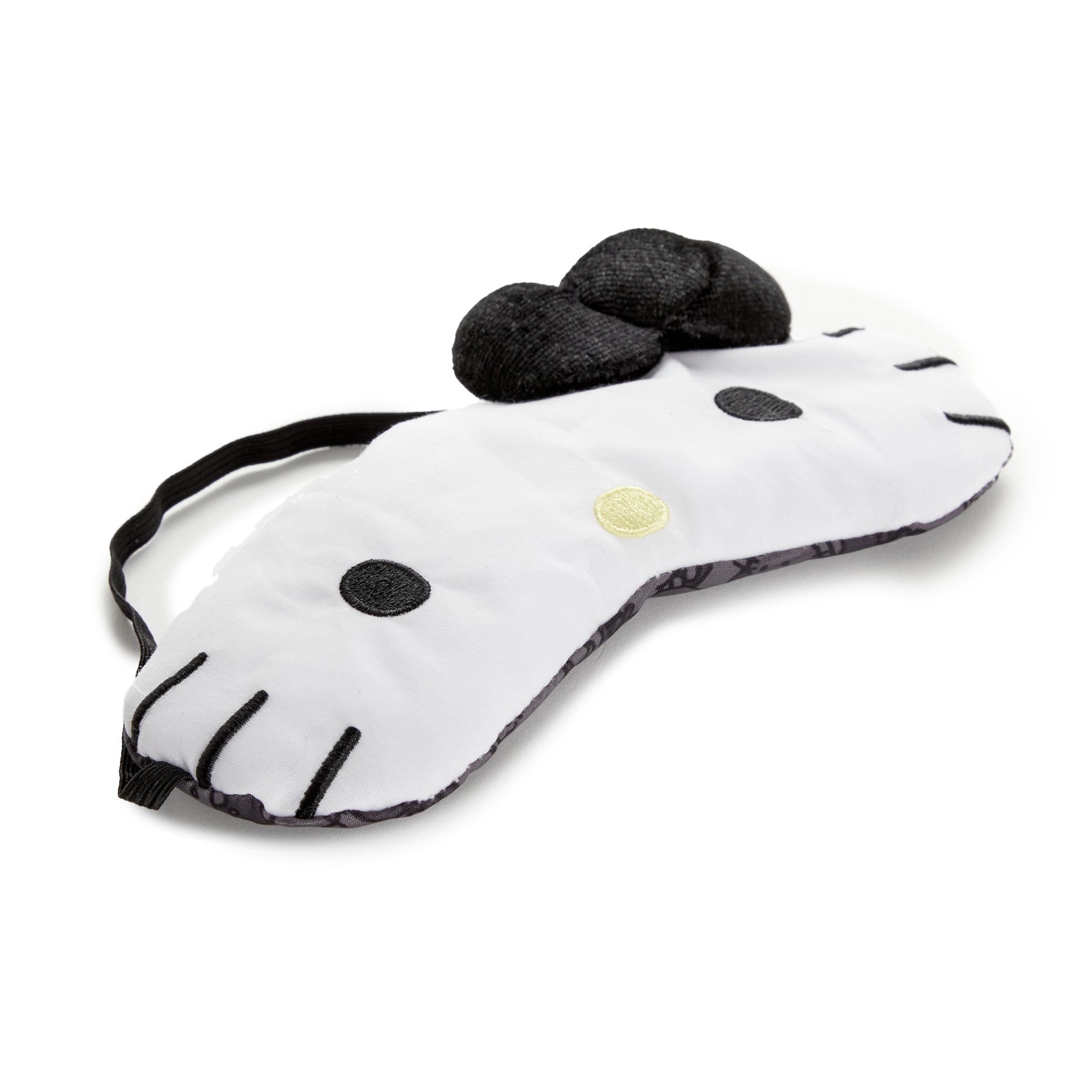 Hello Kitty eye mask on a bedside table, ready for use