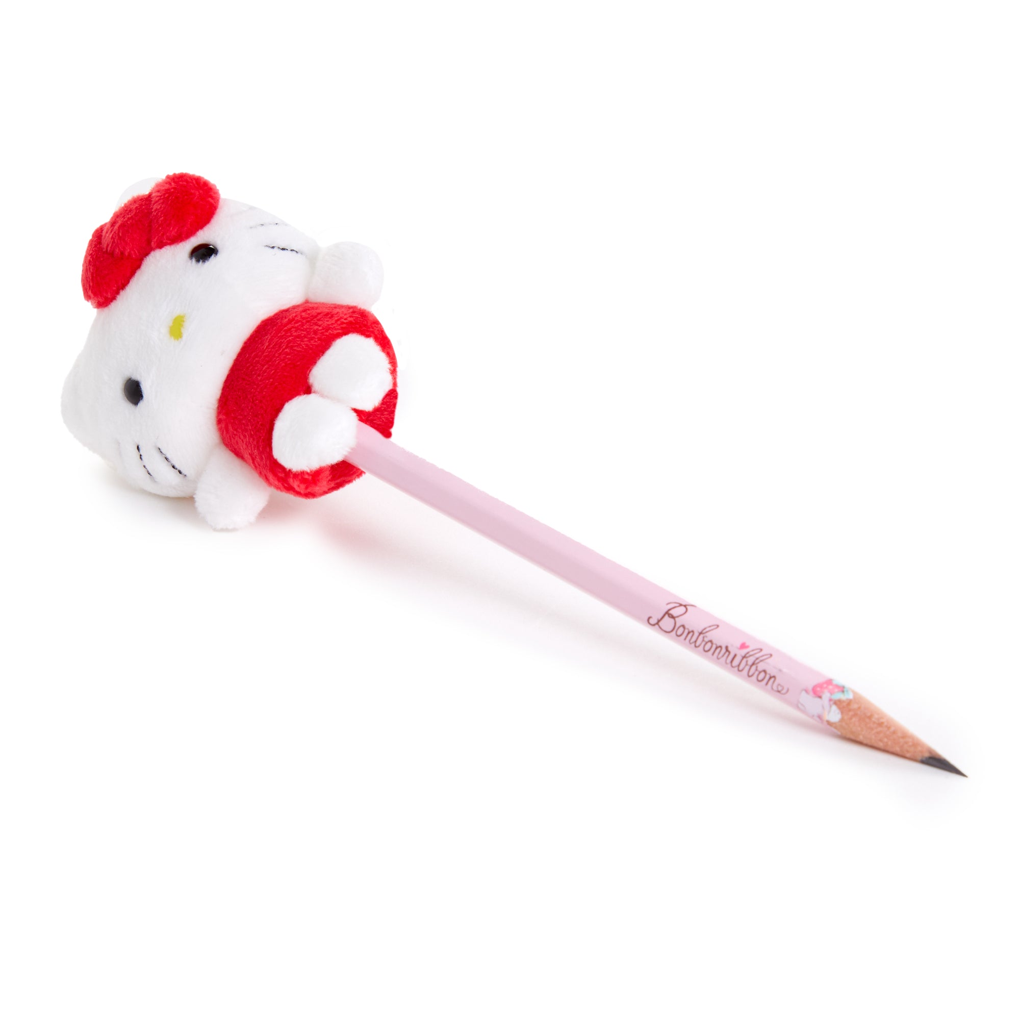 Hello Kitty pencil topper displayed on a notebook alongside other kawaii stationery