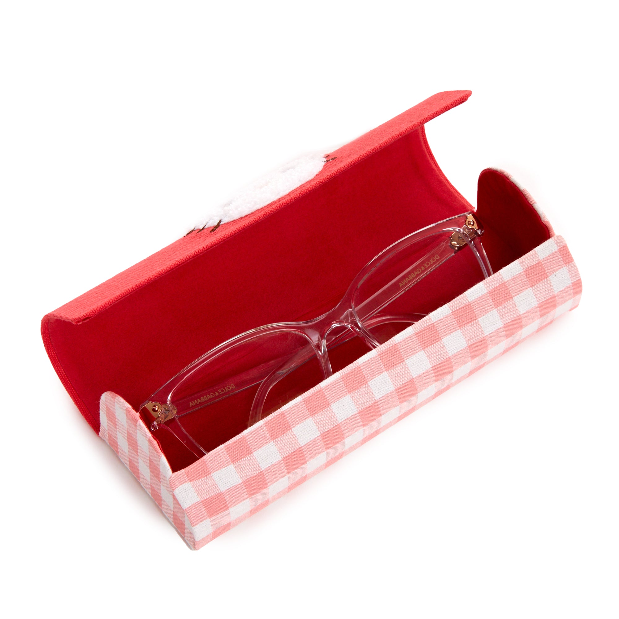 Close-up of the gingham-patterned eyewear case next to a pair of sunglasses.