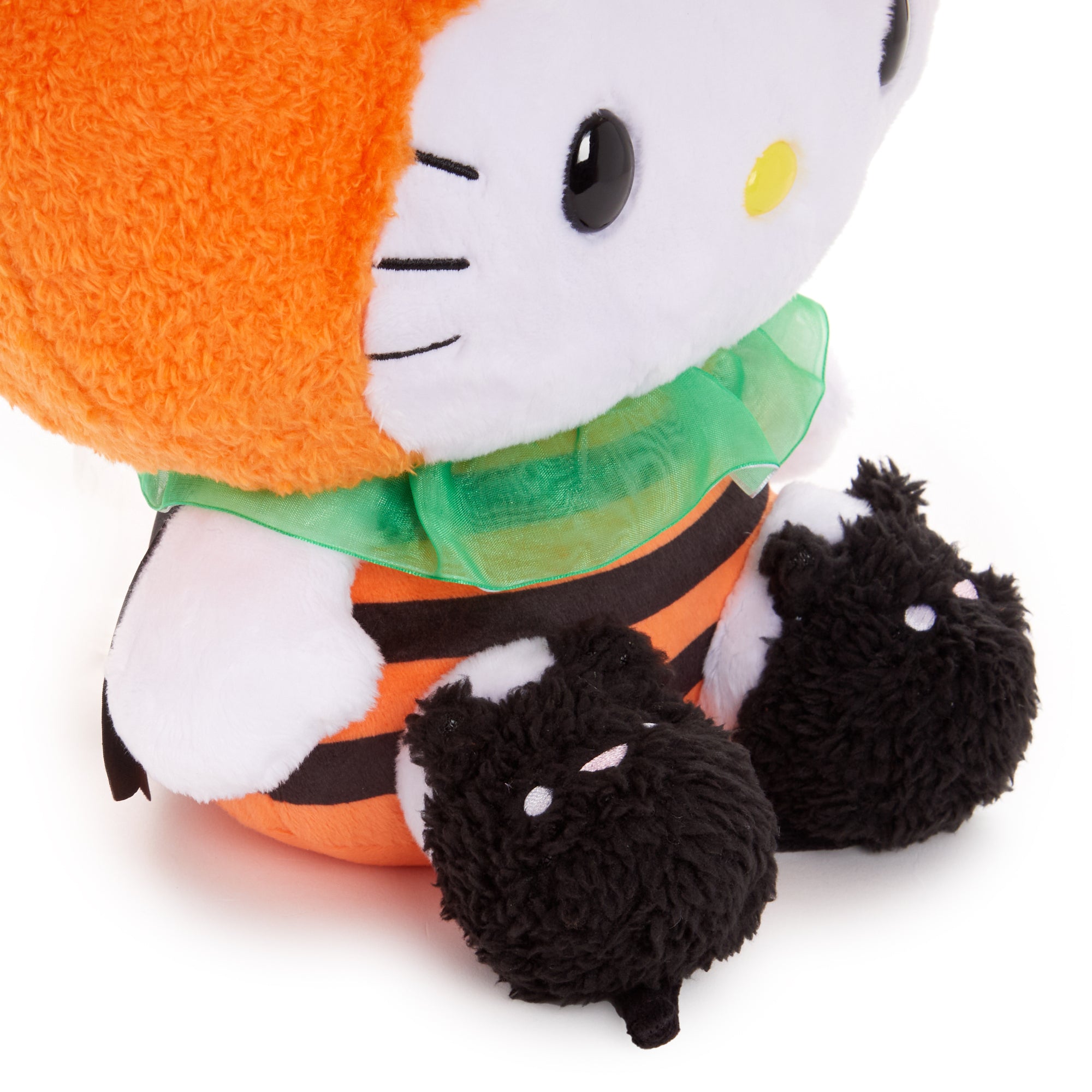 Close-up of Hello Kittys embroidered details on her Halloween plush.