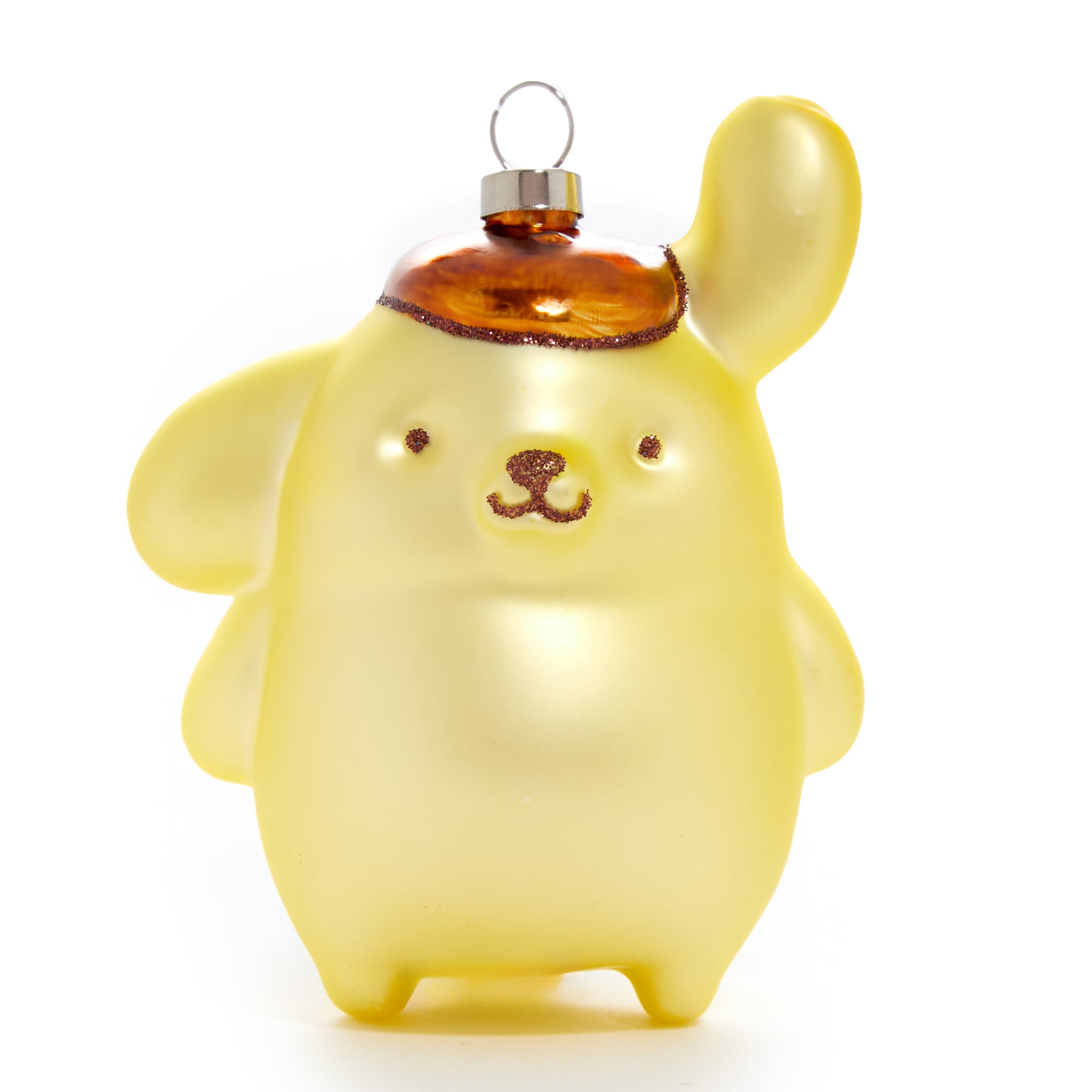 Close-up of Pompompurin glass ornament with festive lights in background.