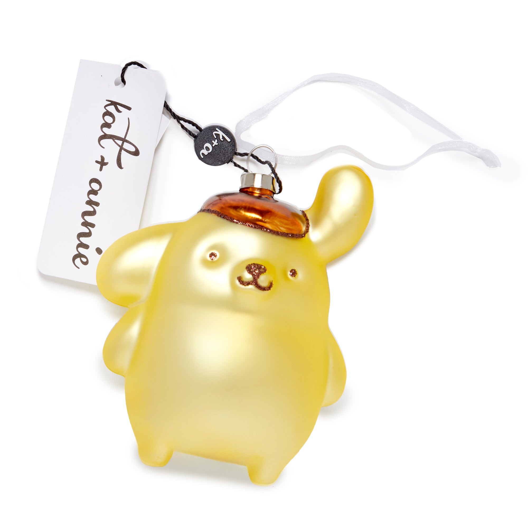 Pompompurin ornament displayed on a holiday-themed table setting.