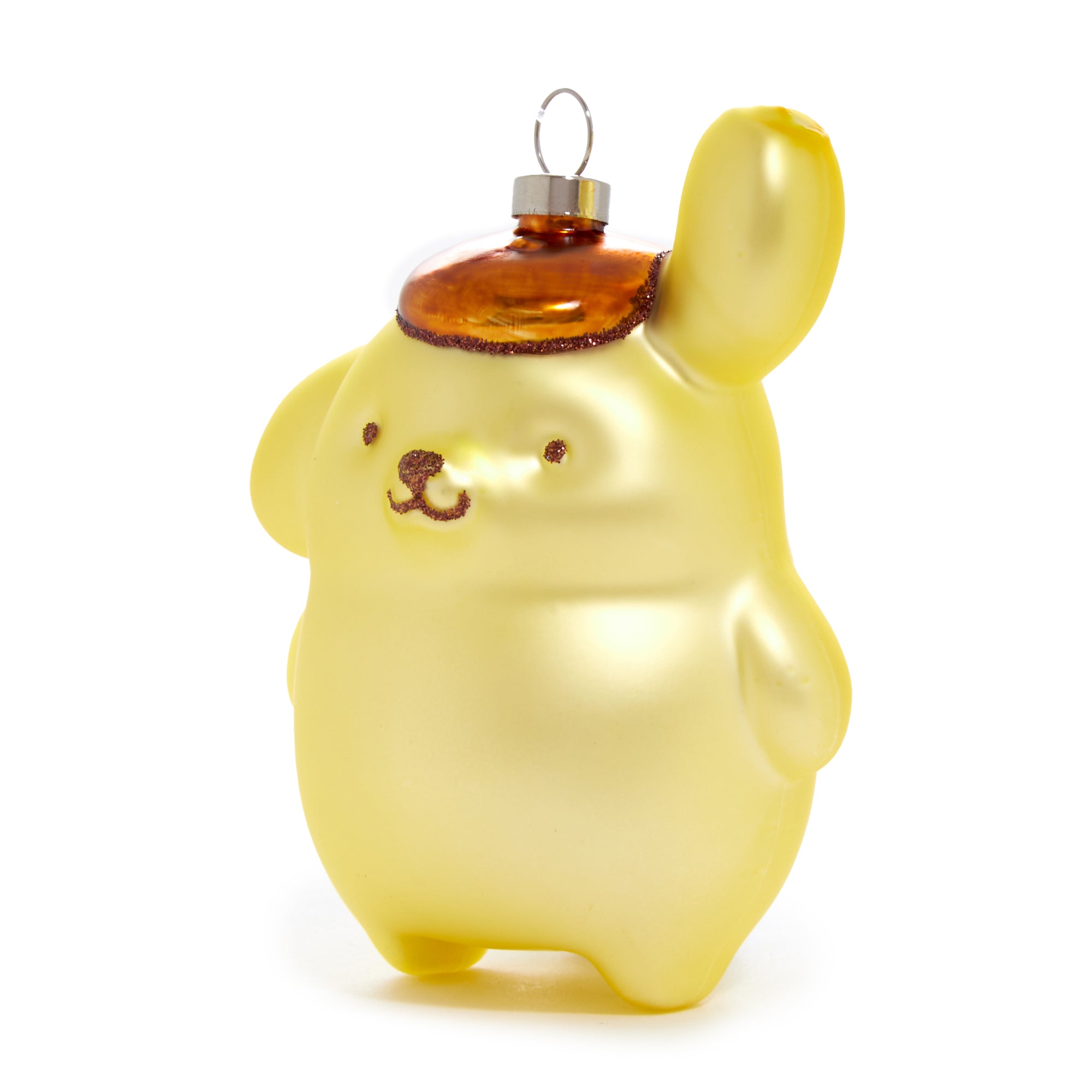 Close-up of Pompompurin glass ornament with festive lights in background.