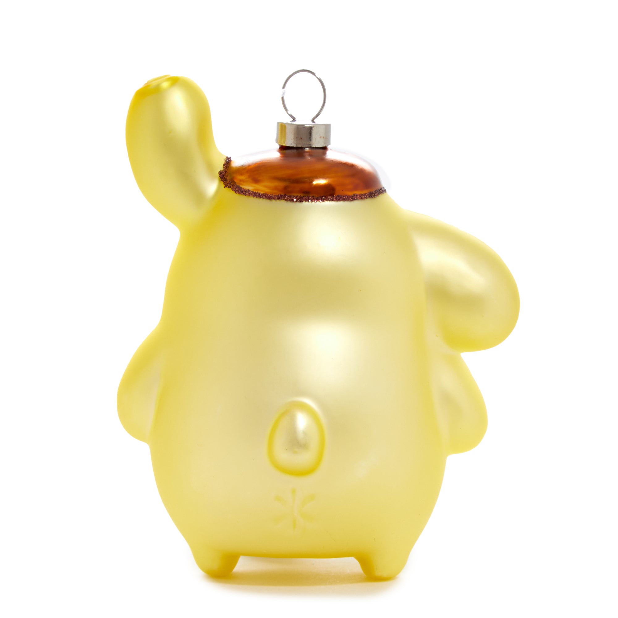 Close-up of Pompompurin glass ornament with festive lights in background.