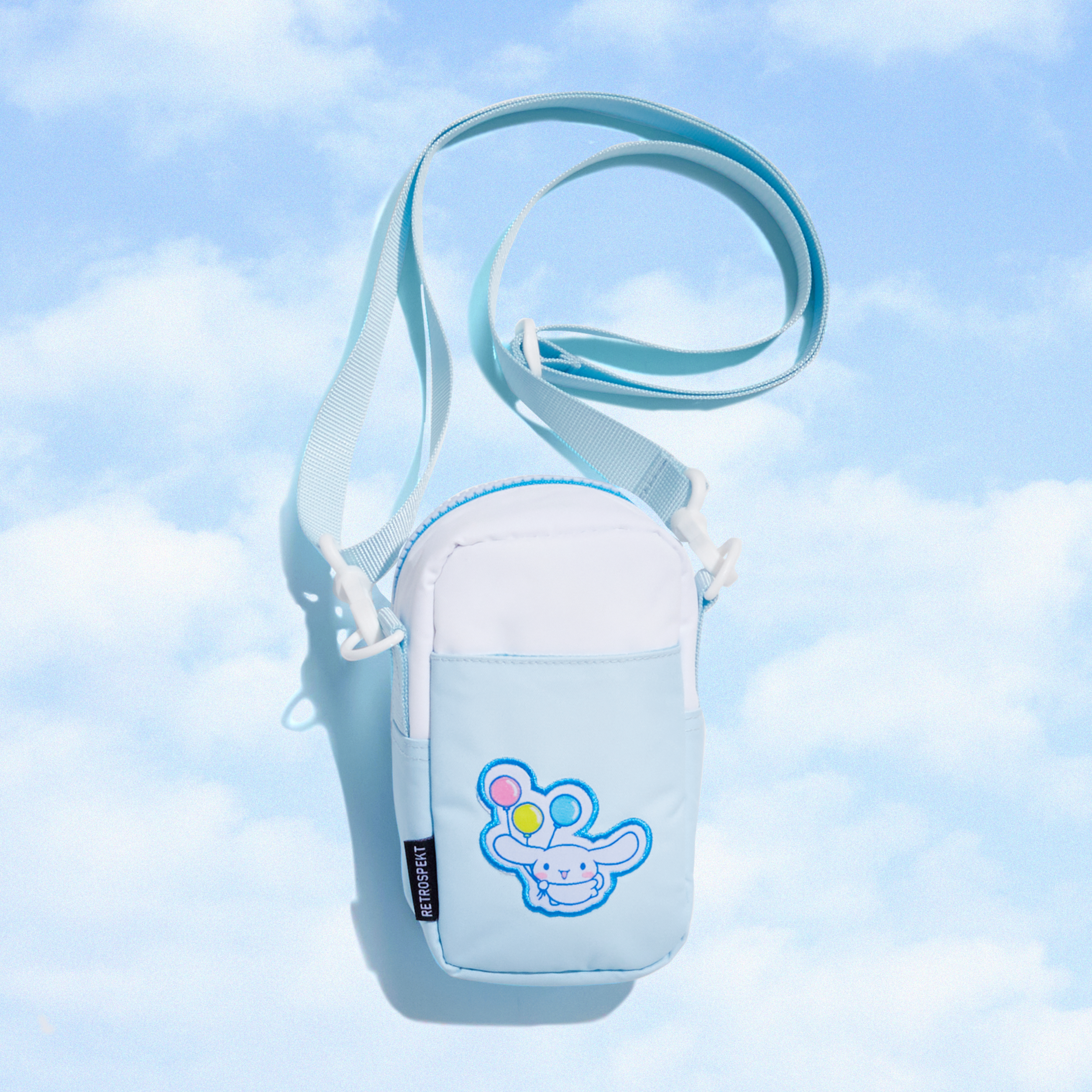 Cinnamoroll camera bag with open zipper showing interior space and camera inside