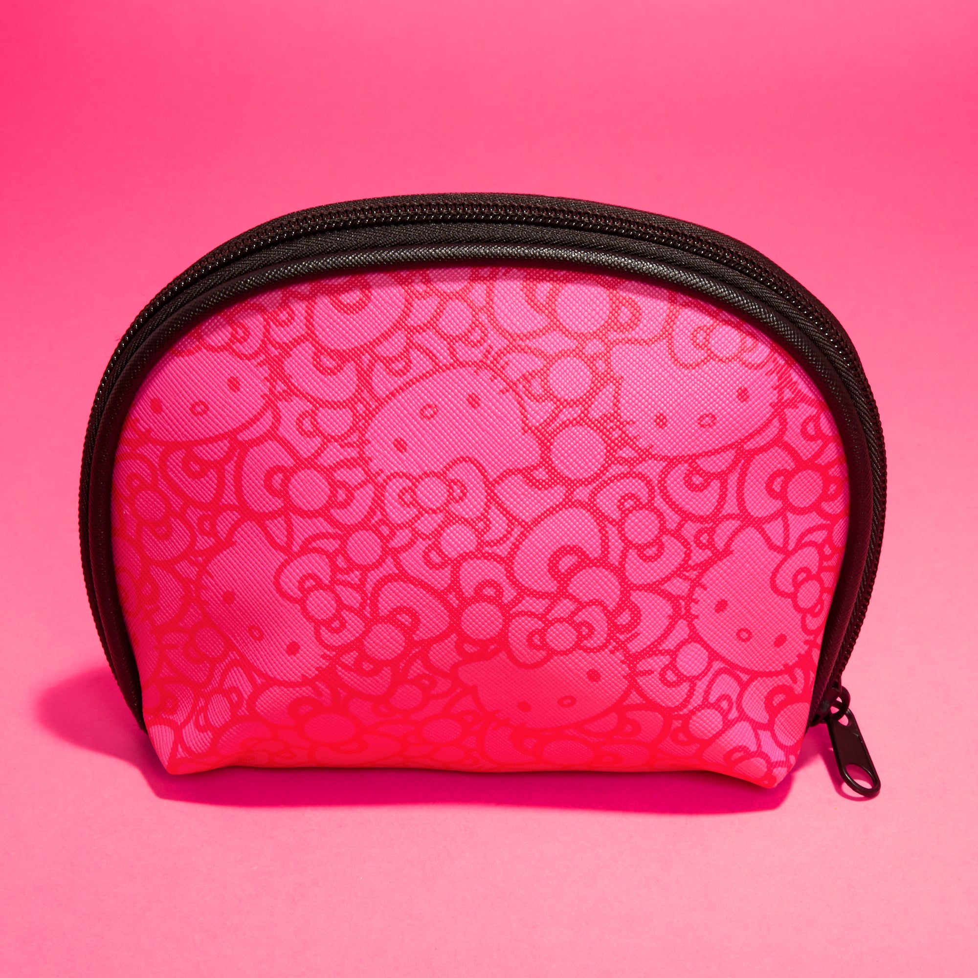 Close-up of the zippered closure on the pink Hello Kitty pouch, showing the fun monochromatic pattern
