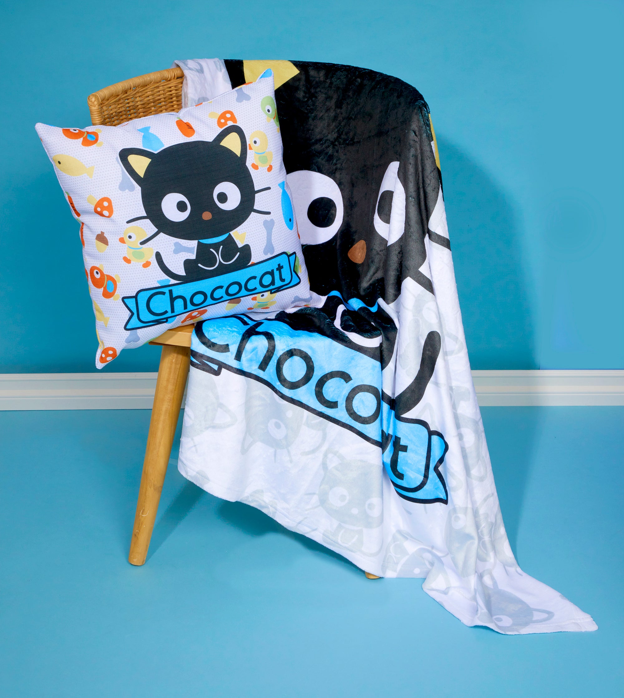 A person relaxing on a sofa with the cat fleece throw blanket for added warmth