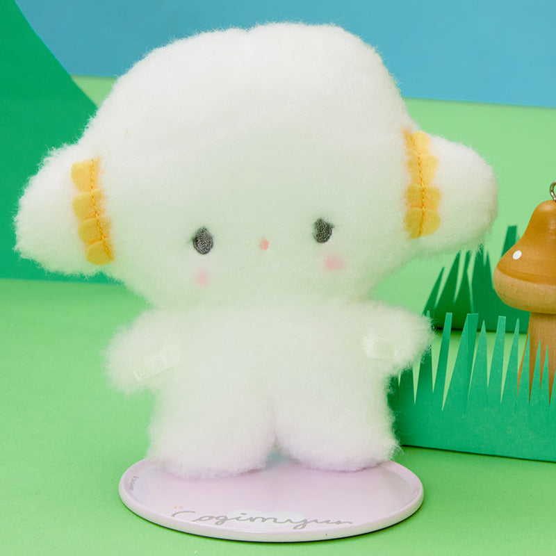 Sanrio Cogimyun plush doll displayed on a bookshelf with base