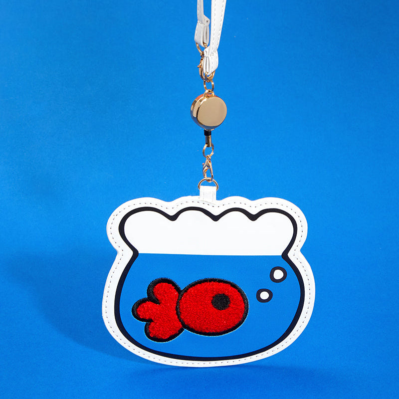 Open Hello Kitty card case displaying clear ID window and key reel.