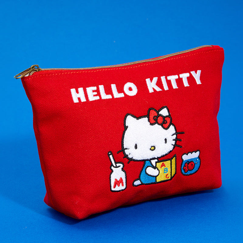 Close-up of the embroidered Hello Kitty design on the red zipper pouch