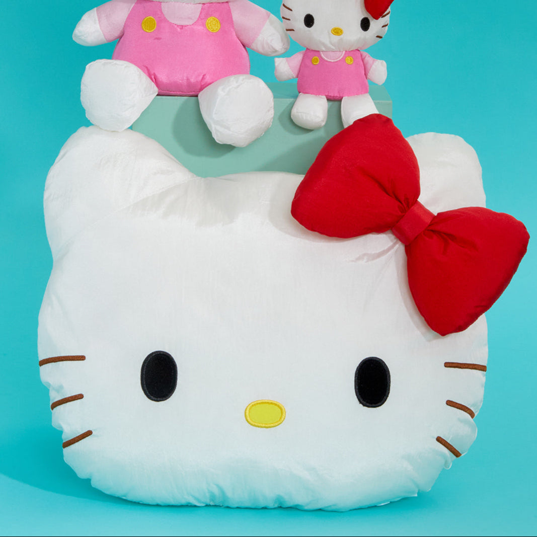 Close-up of Hello Kitty graduation plush with embroidered details.
