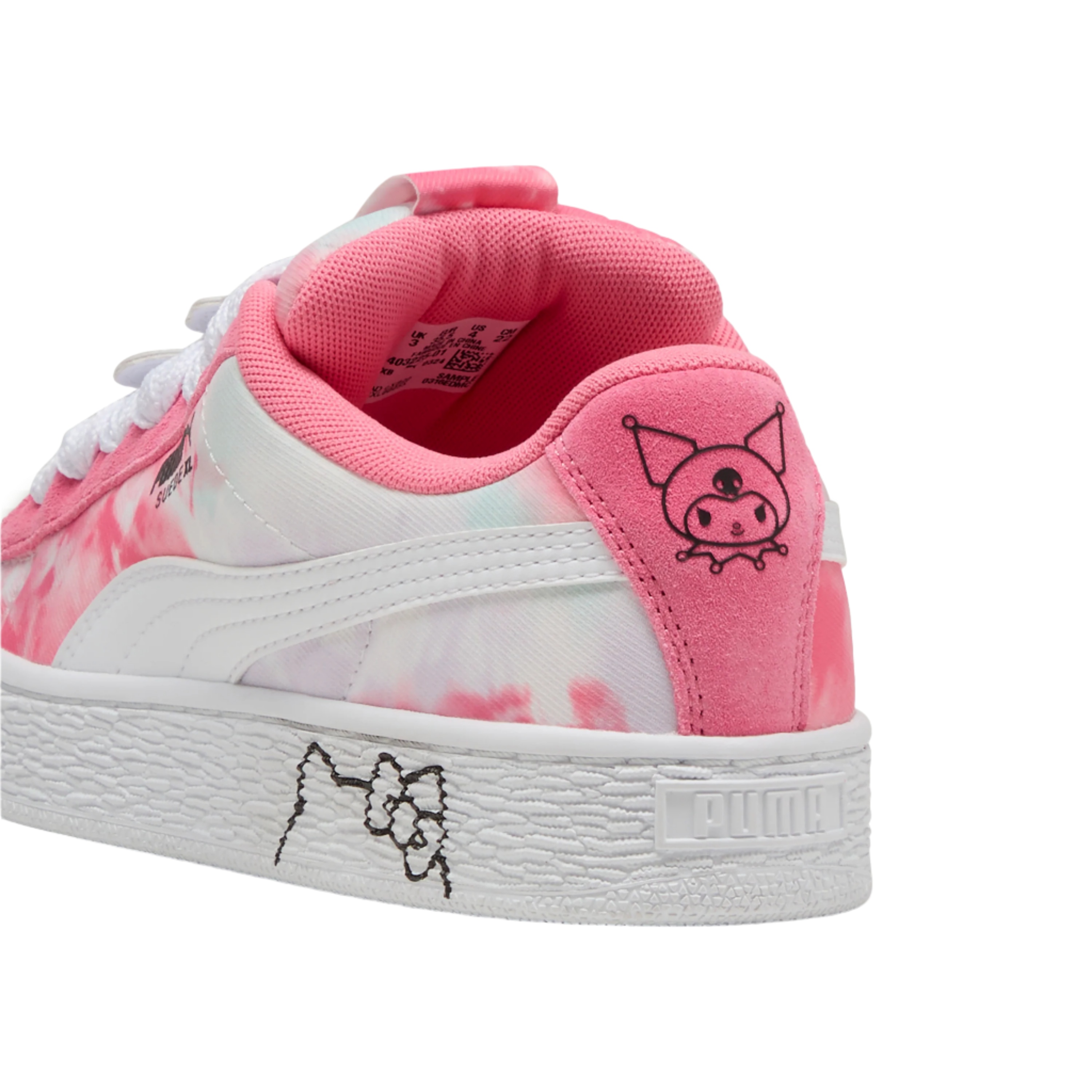 Child wearing black PUMA Suede XL sneakers on urban playground