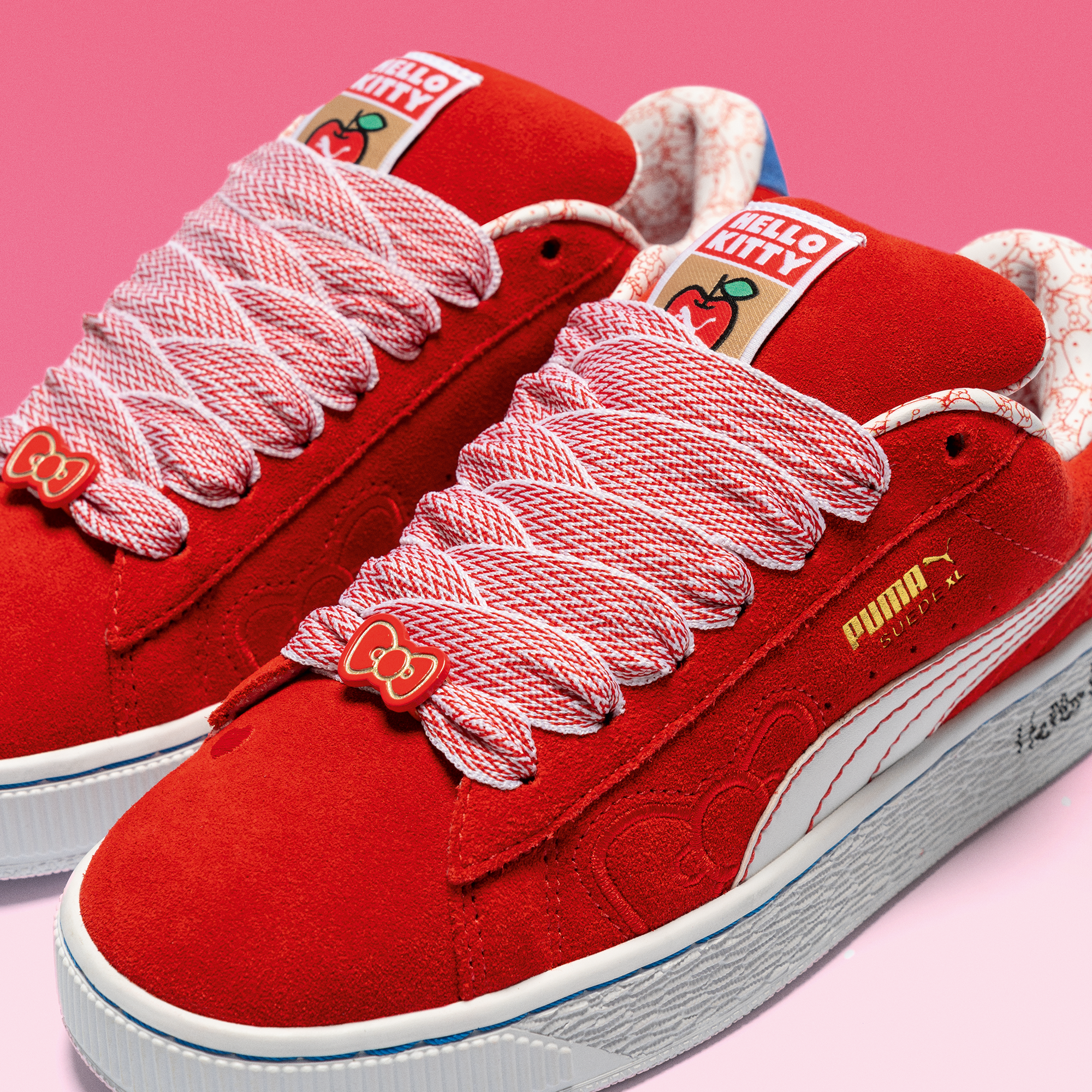Hello Kitty x PUMA Womens Red Bow Suede XL Sneakers side view, showcasing the suede upper and thick laces