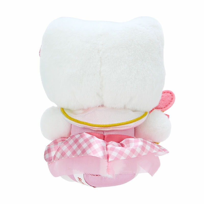 Hello Kitty keychain plush attached to a denim backpack strap