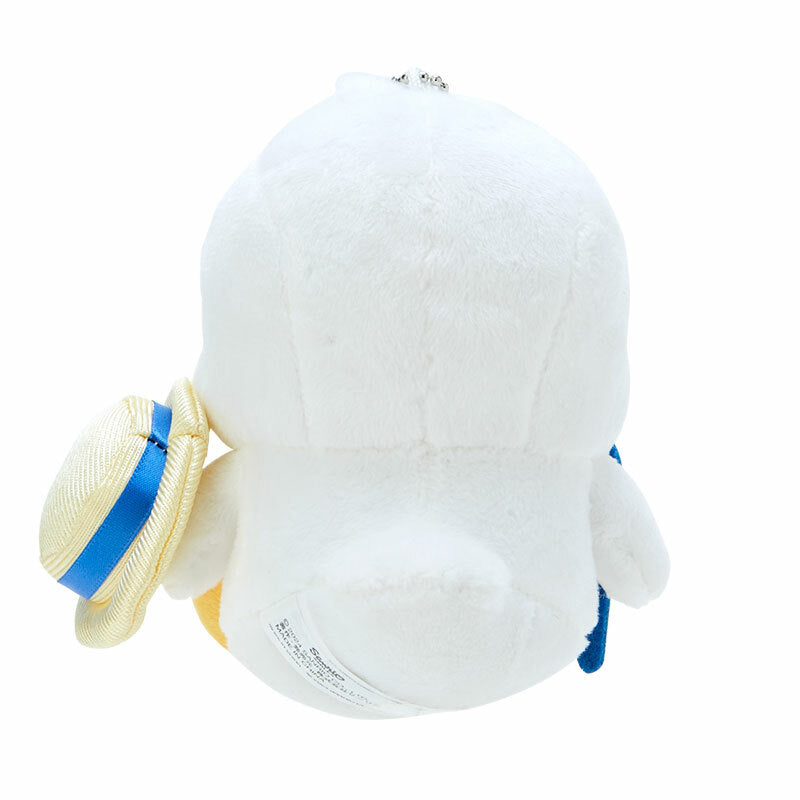 Side angle of Pekkle plush keychain hanging on a denim backpack