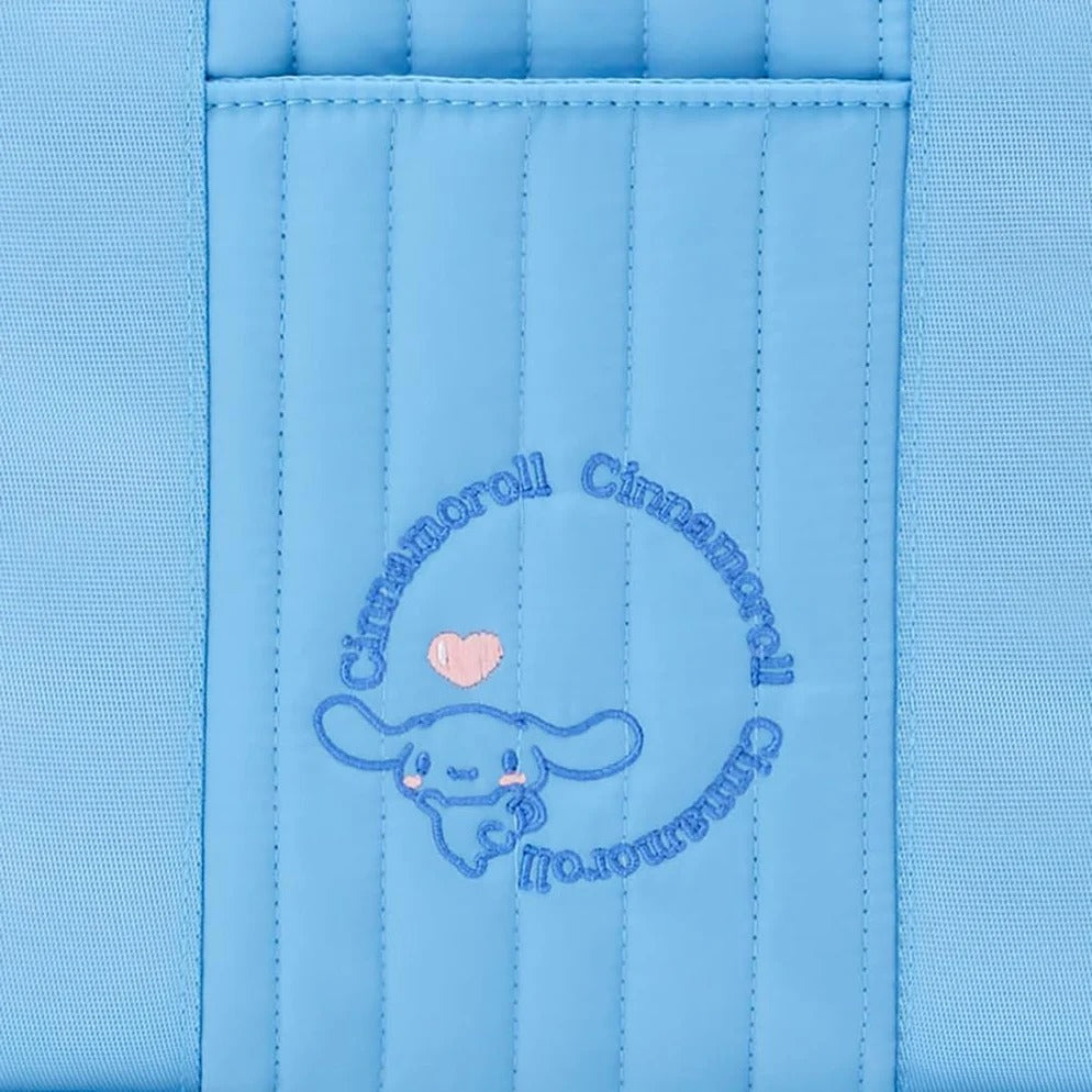 Black quilted tote bag with Cinnamoroll design, being used as a daily tote