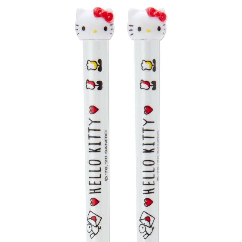 Child using fun chopsticks with a cheerful Hello Kitty mascot at the dinner table