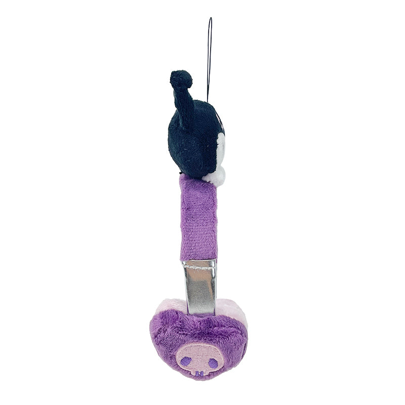 Kuromi plush toy charm hanging from a purse in a sunny outdoor setting