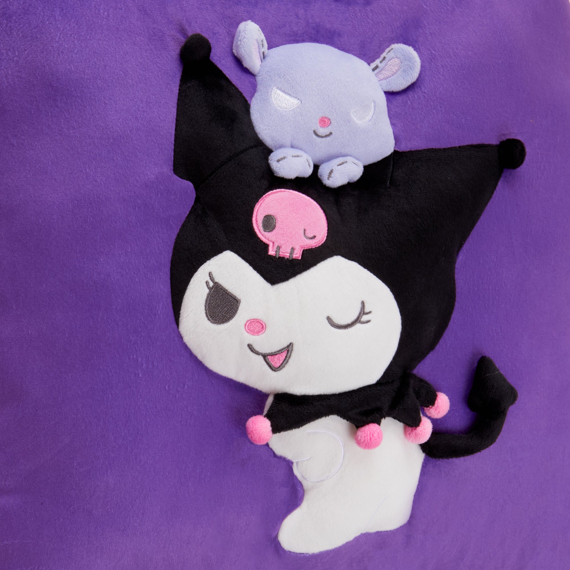 Kuromi throw pillow outdoors on a patio bench with other outdoor throw pillows