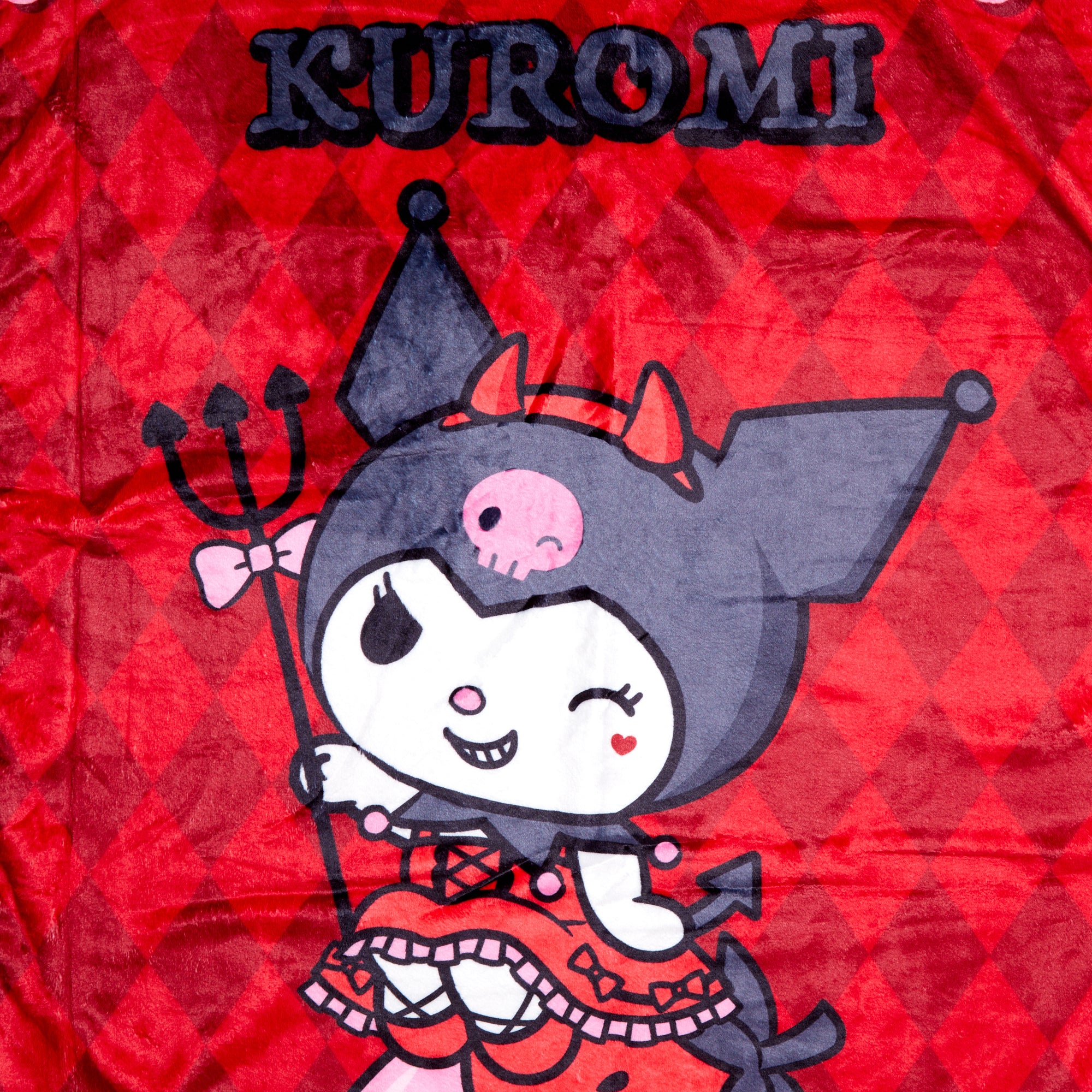 Kuromi-themed throw blanket draped over a couch, showcasing colorful character graphics