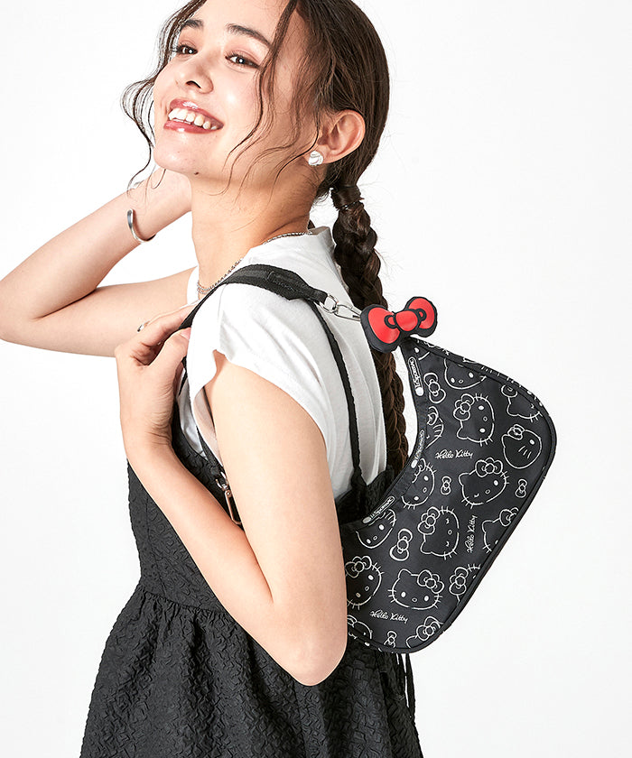 Interior shot of hello kitty cosmetic bag with visible open pocket and metal hardware