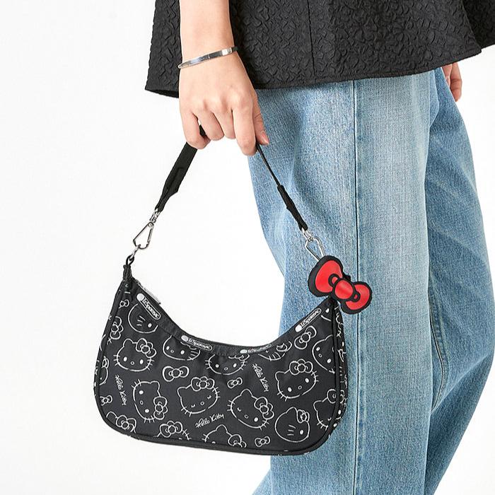 Interior shot of hello kitty cosmetic bag with visible open pocket and metal hardware