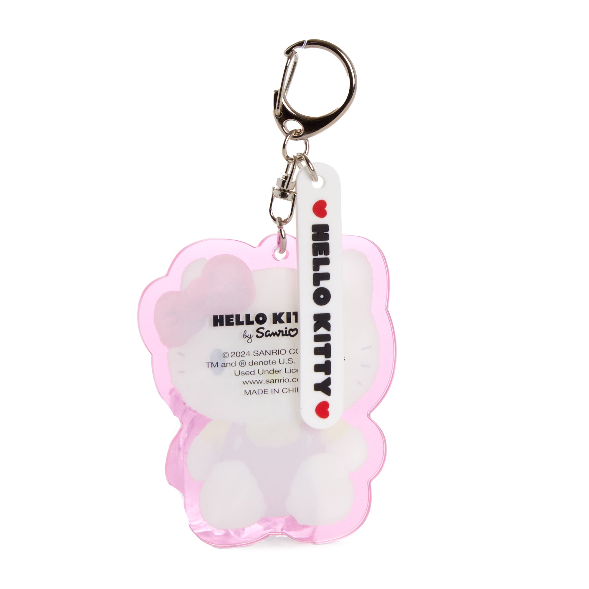 Hand holding the kawaii keychain against a pastel background