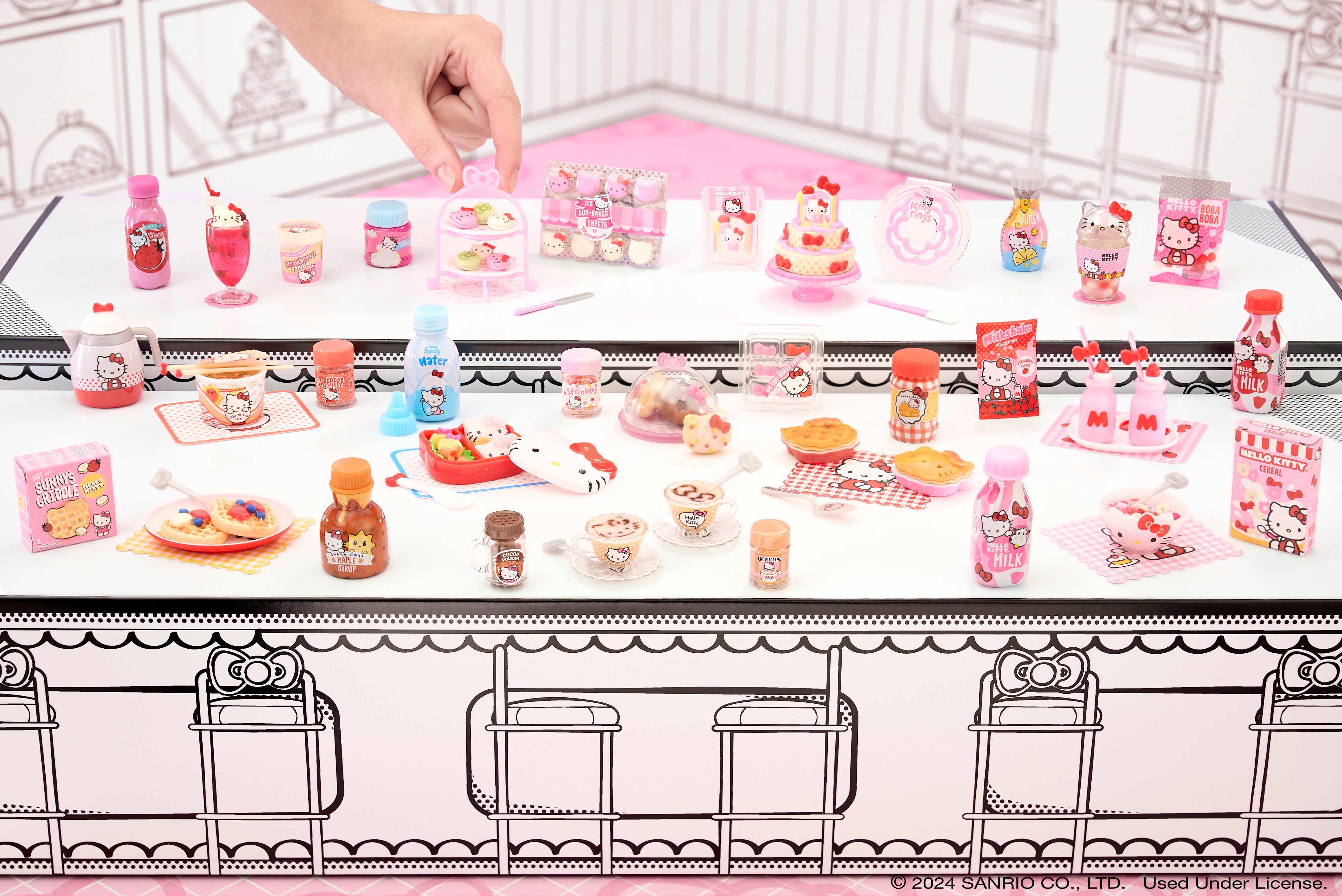 Close-up of Hello Kitty-themed mini food items in a display case.