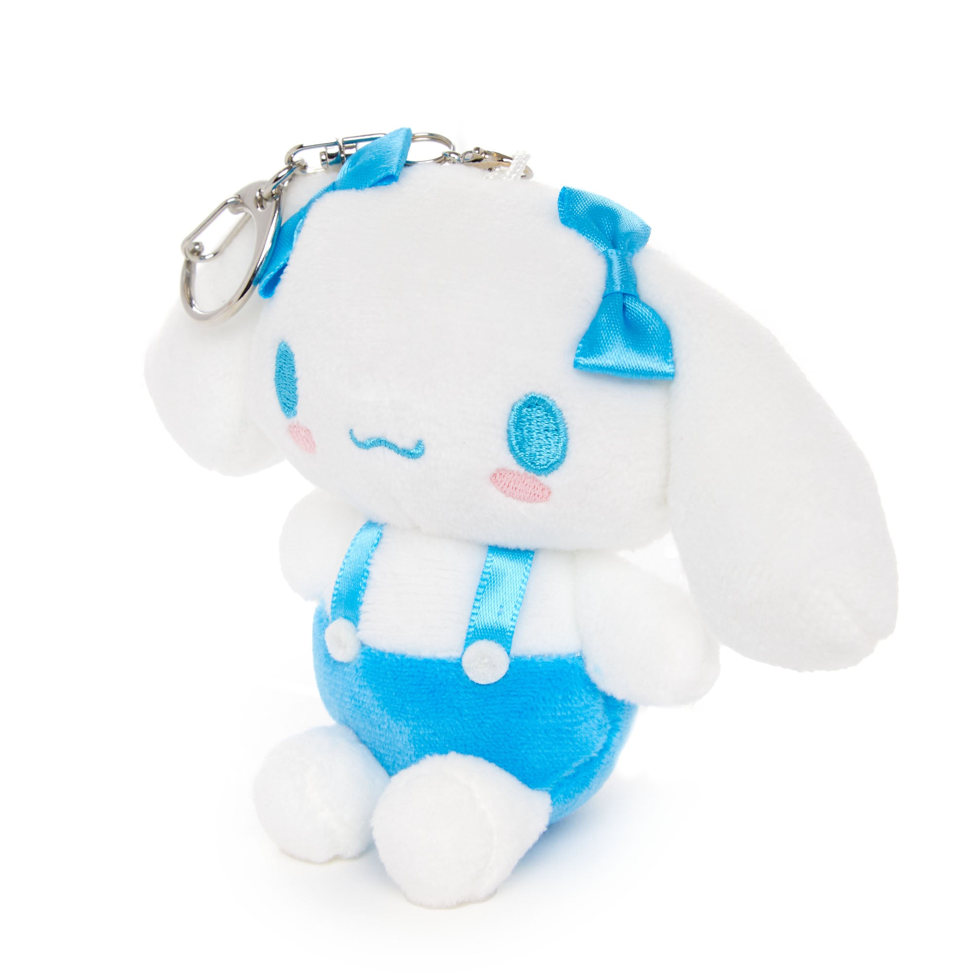 Sanrio mocha plush mascot hanging from a student backpack zipper