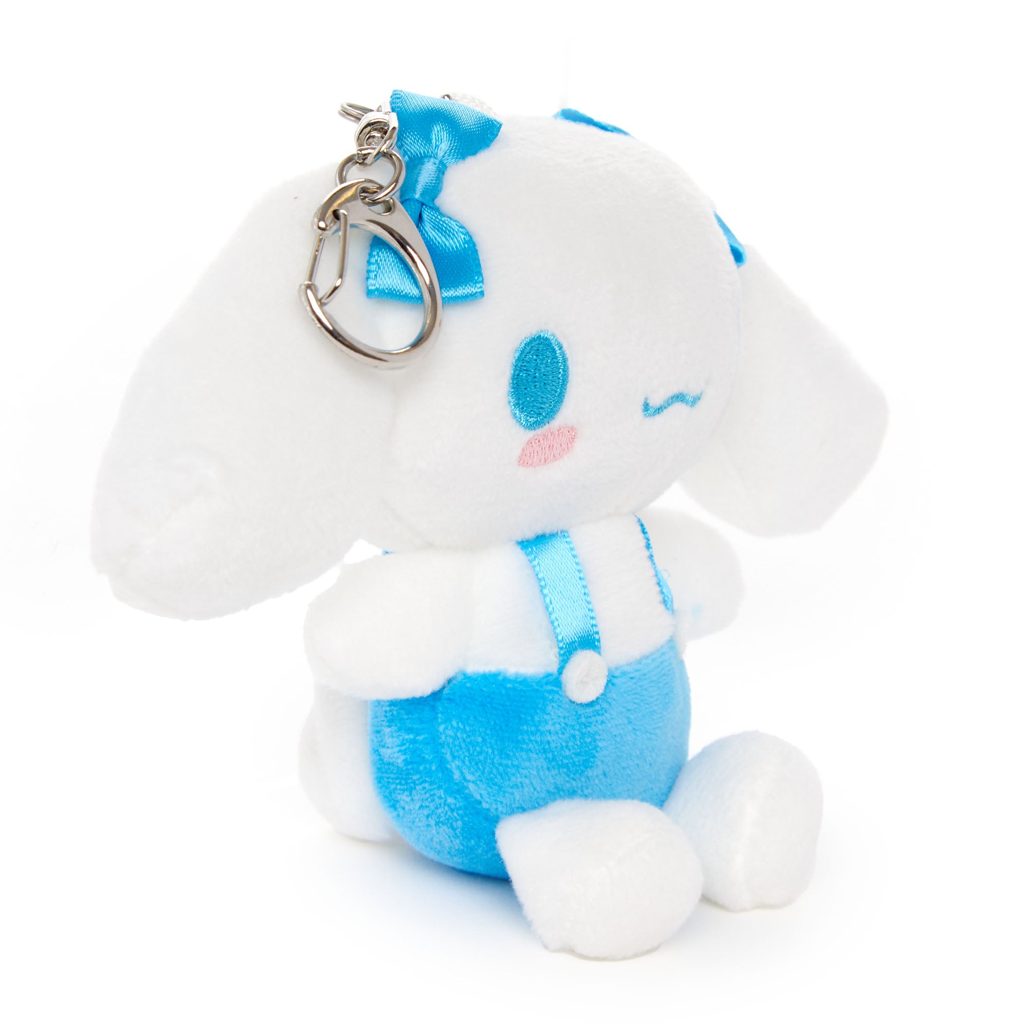 Cinnamoroll plush keychain displayed on a denim jacket pocket