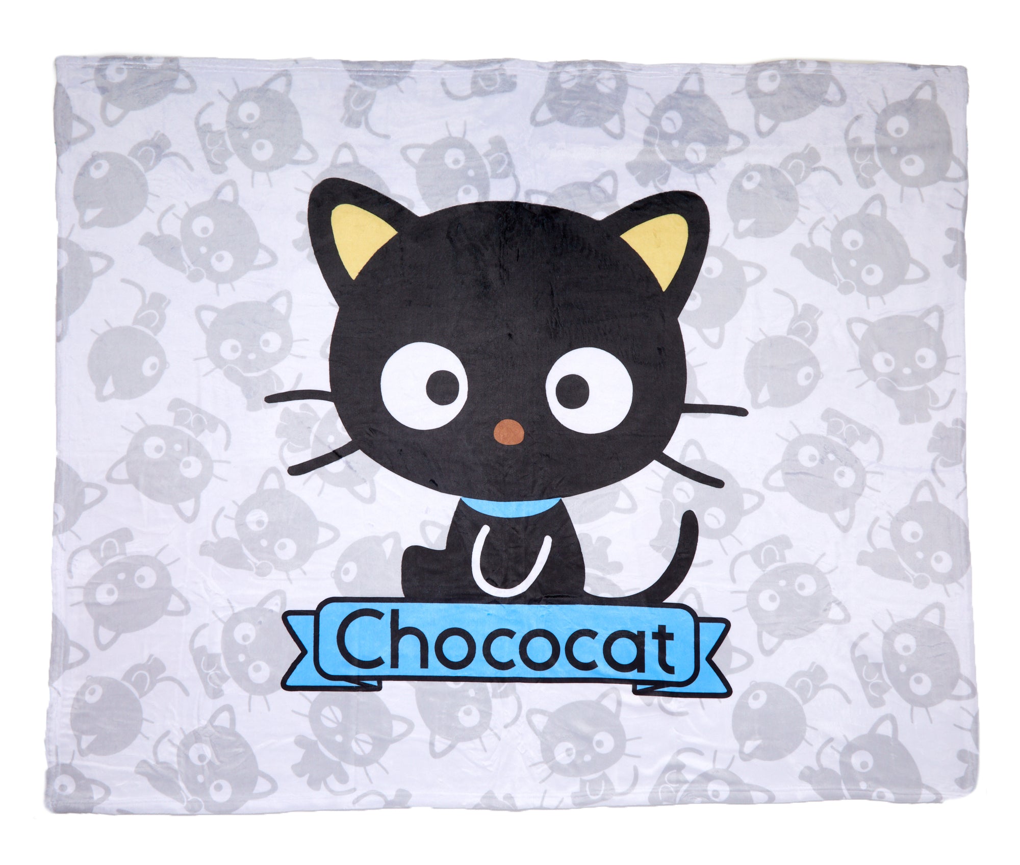 Chococat fleece throw blanket folded on a sofa, showcasing its soft texture.