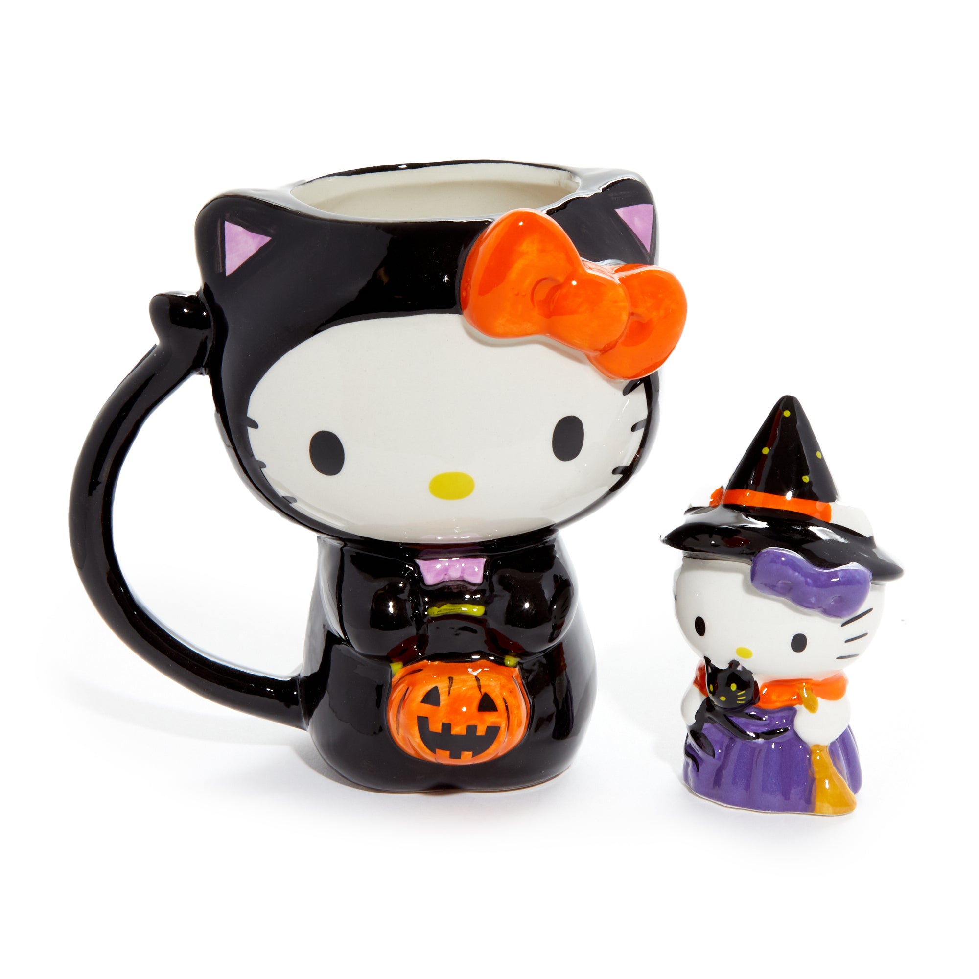 Hello Kitty Halloween ceramic mug and figurine set displayed together. Hello Kitty Halloween ceramic mug and figurine set displayed together.