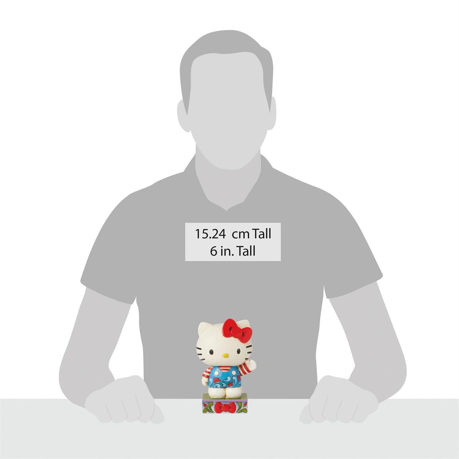 Front view of Hello Kitty crystal figurine in Jim Shore rosemale overalls – ideal Sanrio figurines gift