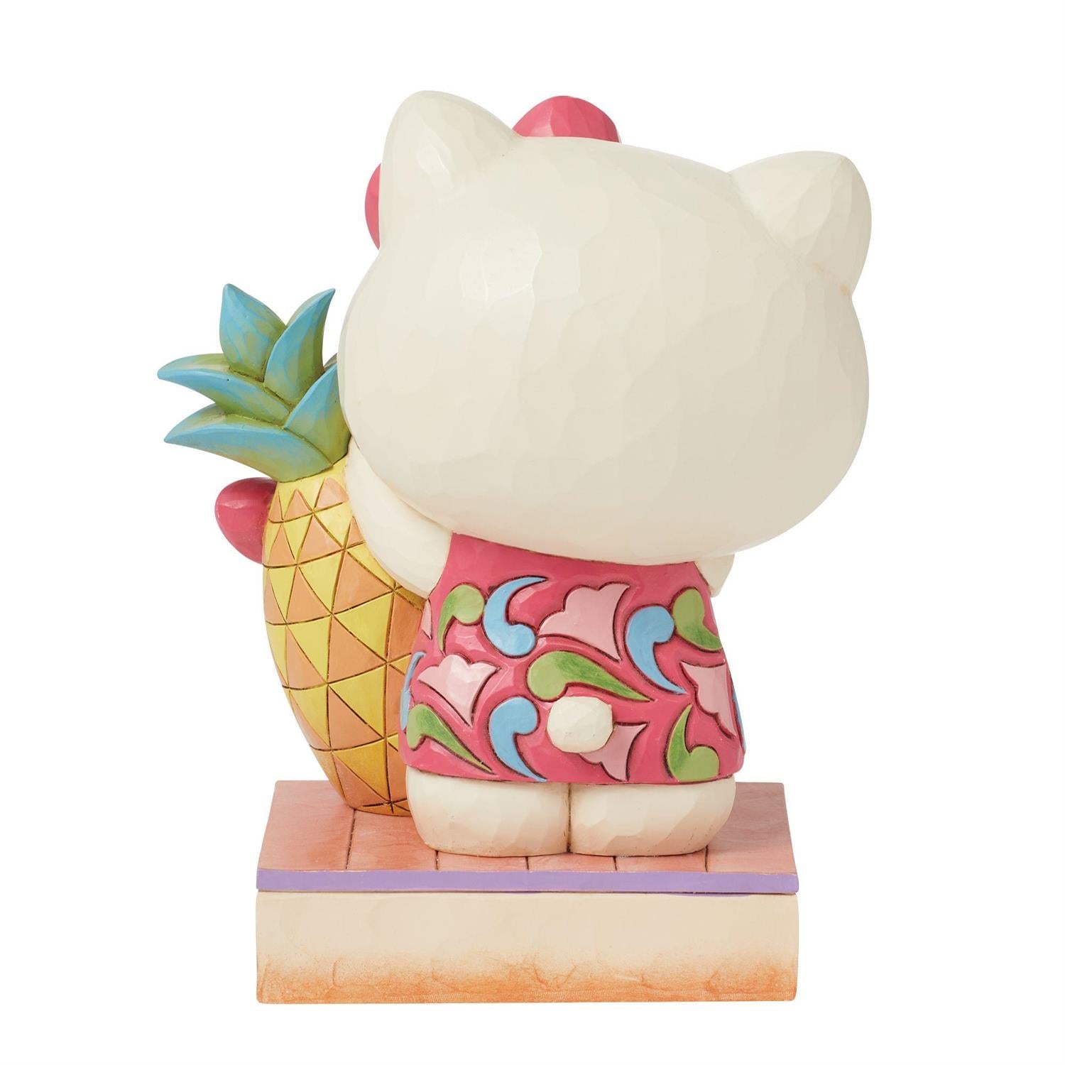 Close-up of the figurine’s hand-painted pineapple and rosemaling patterns