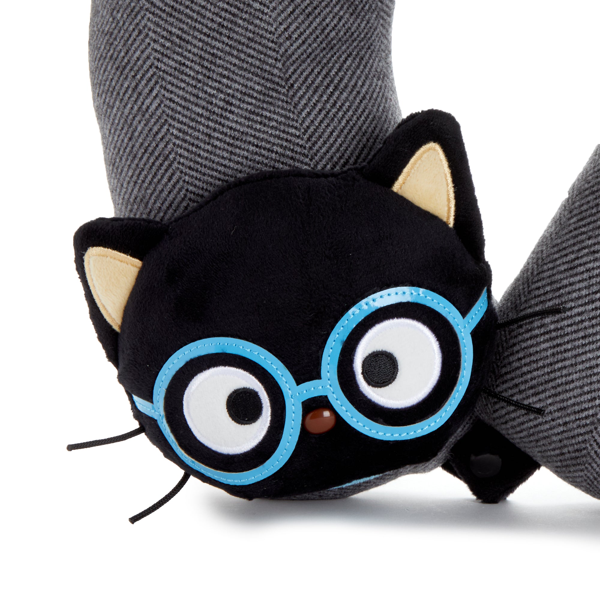 Chococat pillow resting on winter luggage — perfect neck support for long flights.