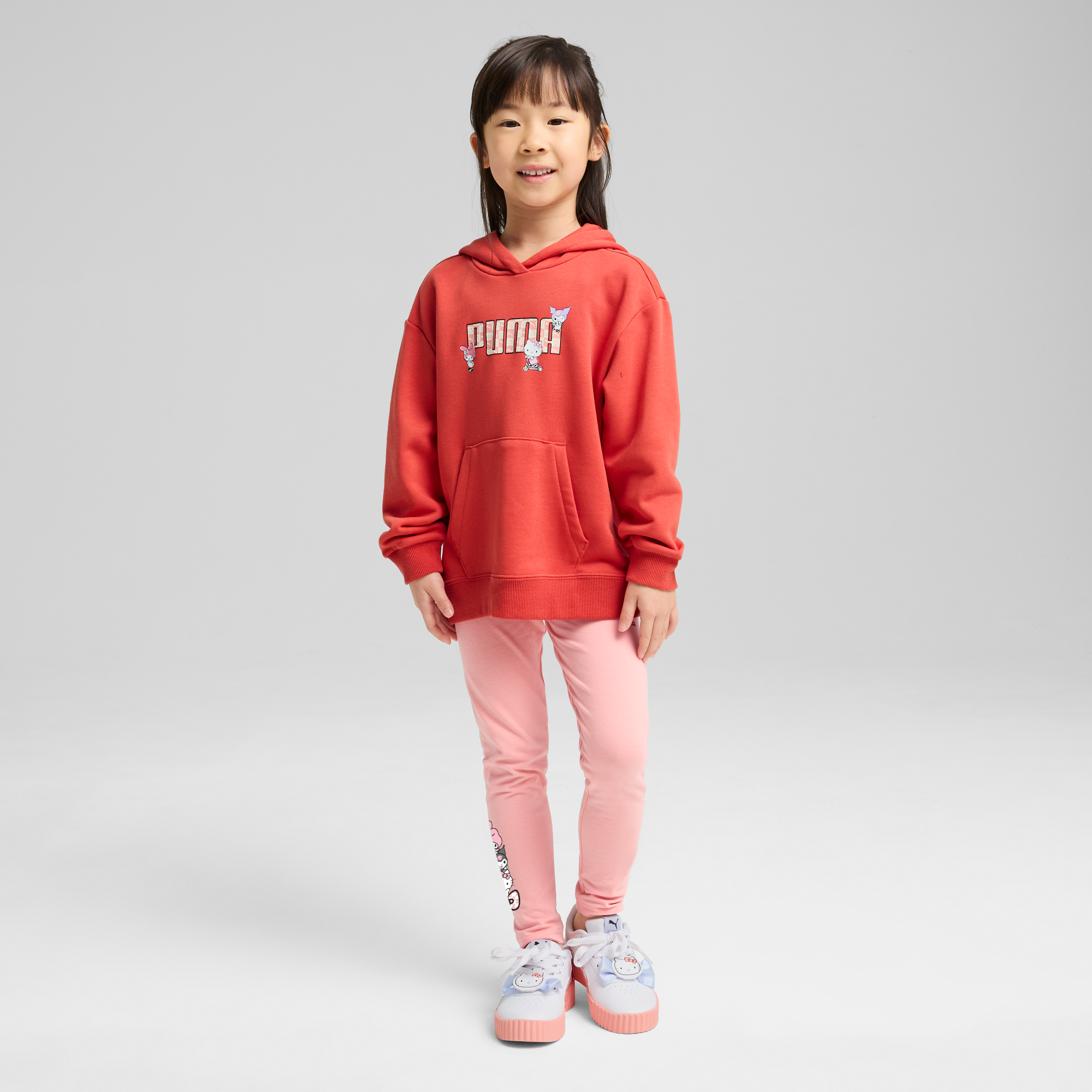 Close-up of the PUMA co-branded gradient print and bow details on the kids hoodie