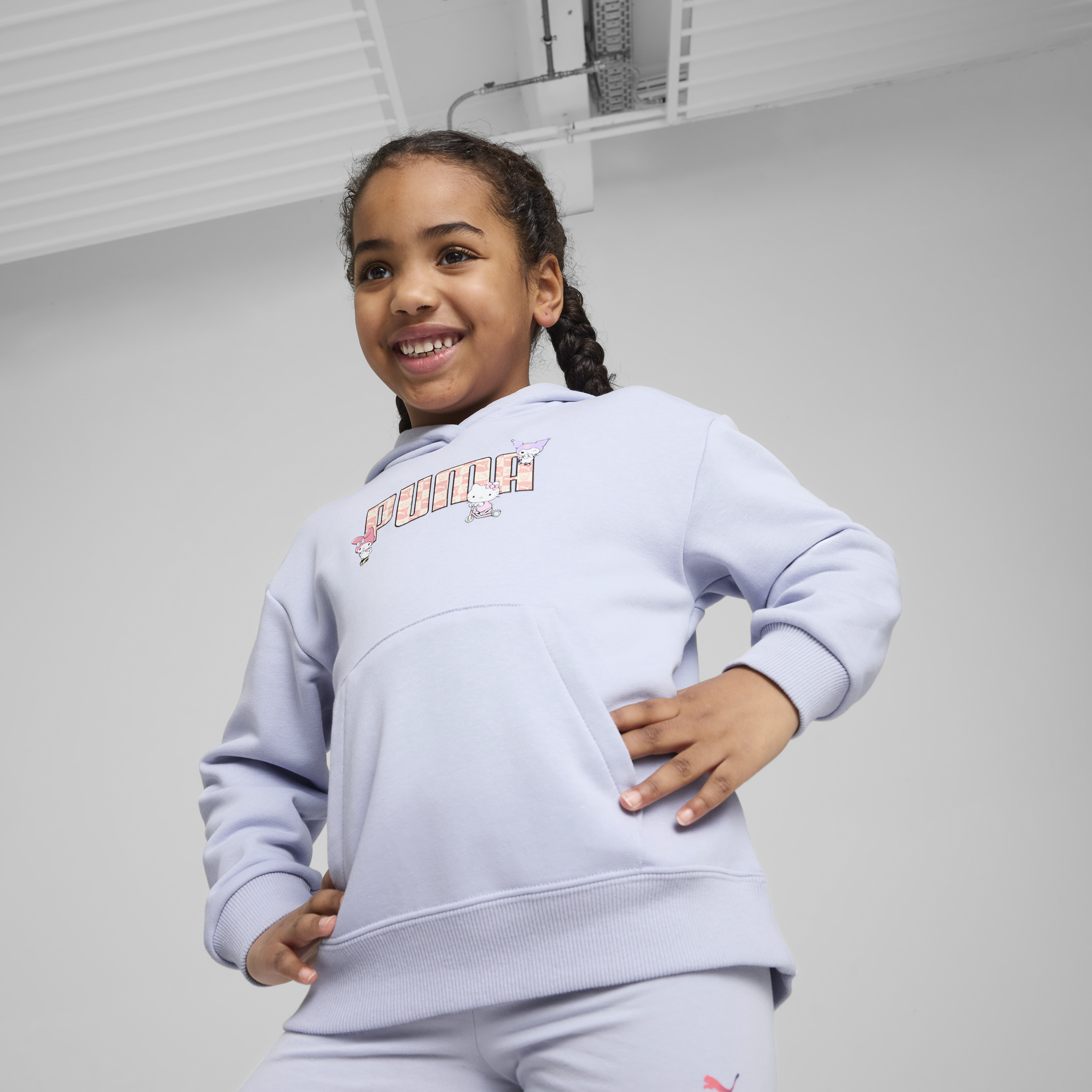 Front view of kids wearing Hello Kitty and PUMA hoodie with playful graphics