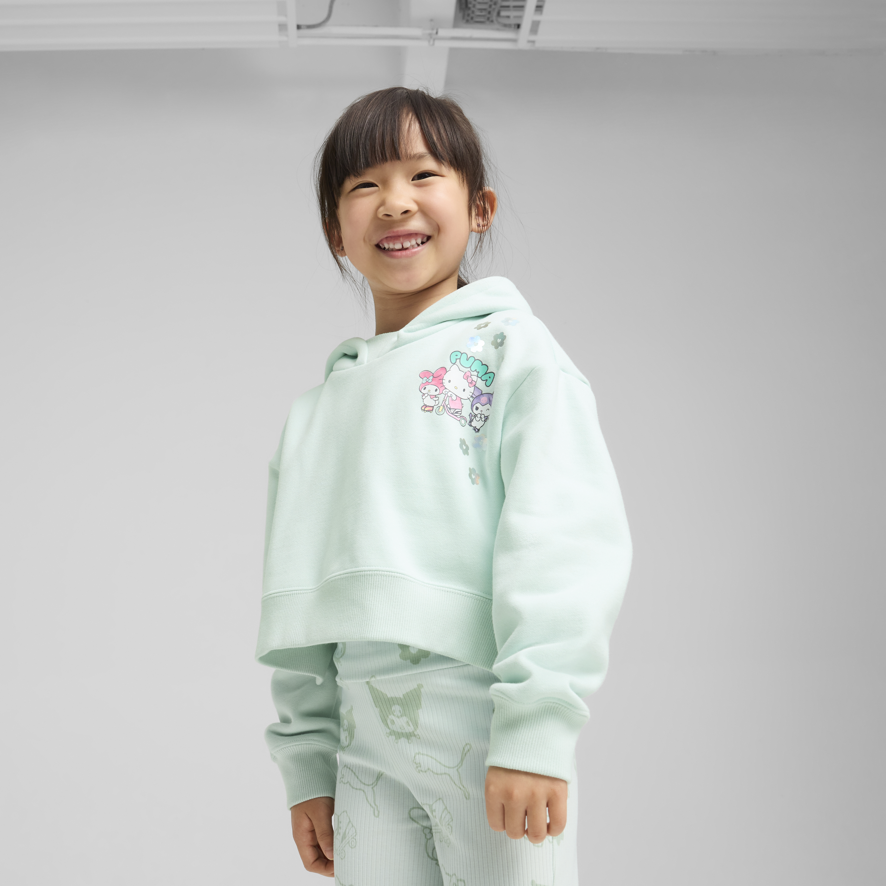 Front view of the PUMA kids hoodie featuring Hello Kitty graphics.