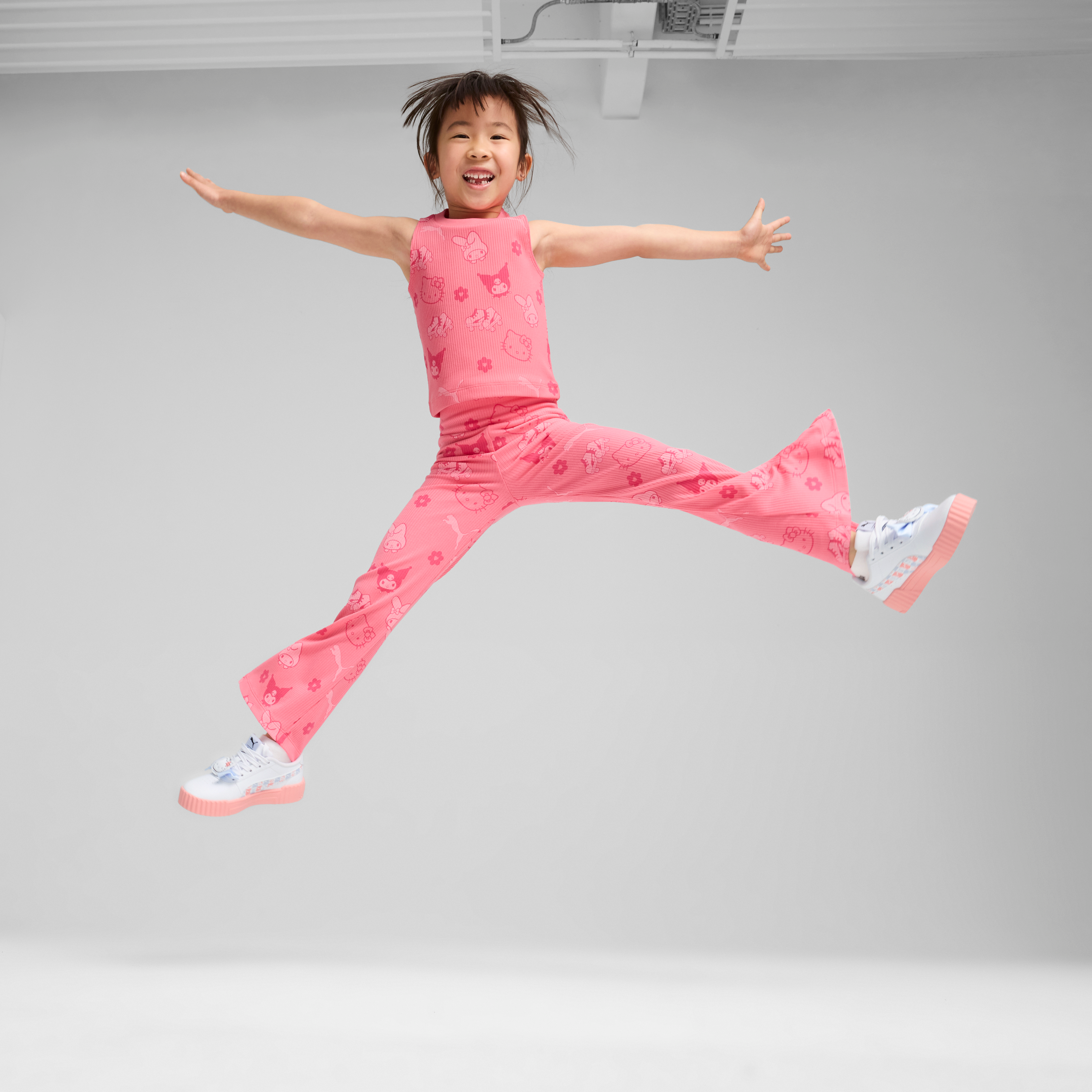 Child playing outdoors in stylish Hello Kitty leggings with all-over print