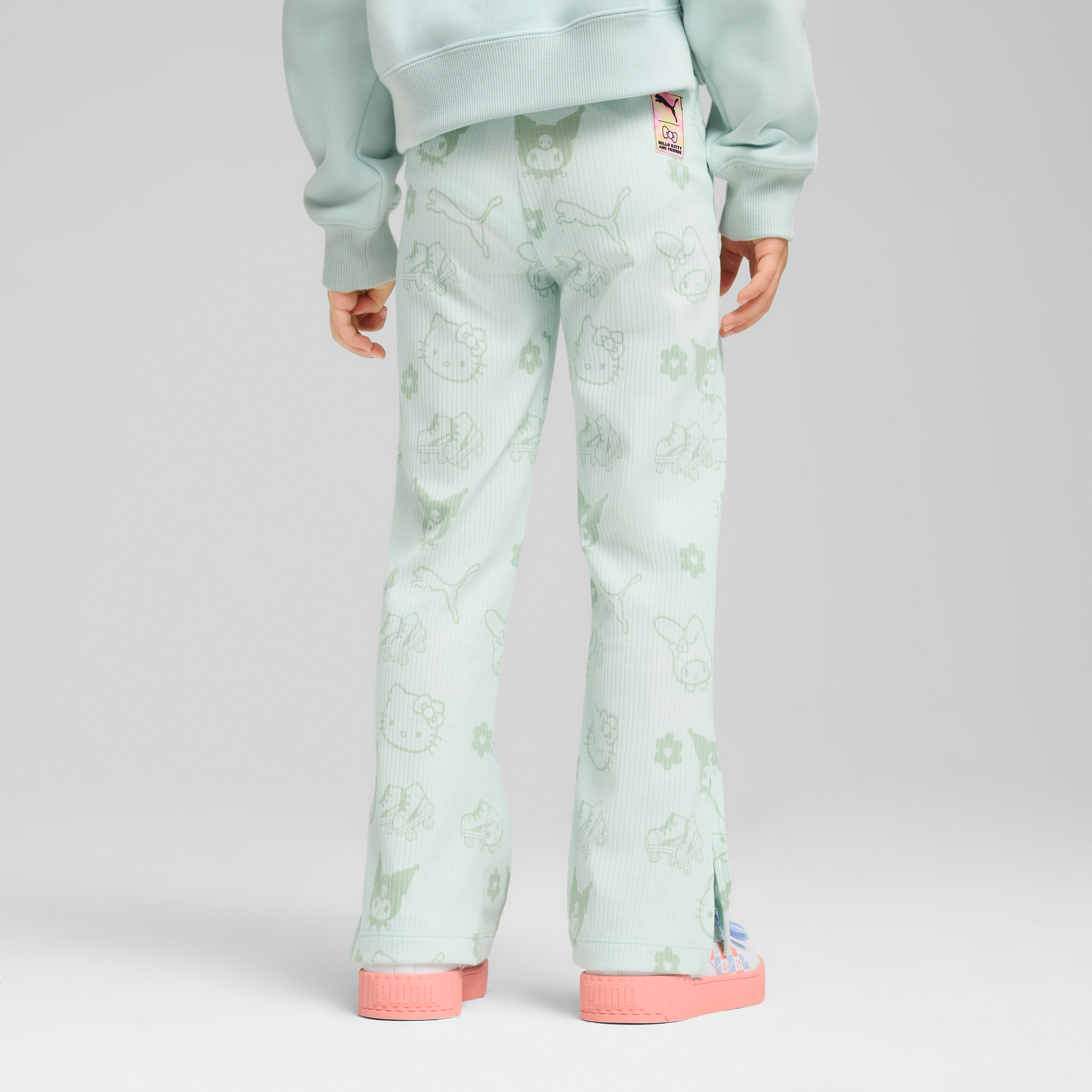 Child modeling flared leggings with playful Hello Kitty artwork.