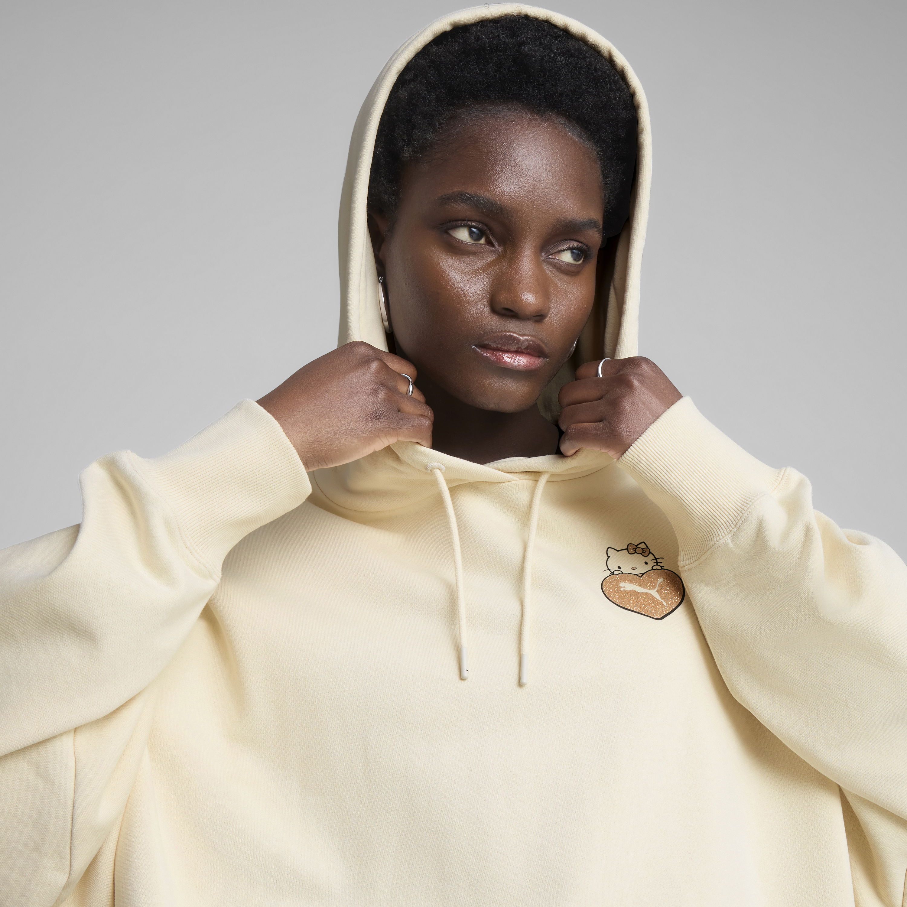 Side view of the oversized hoodie highlighting its relaxed fit and rib-knit cuffs.