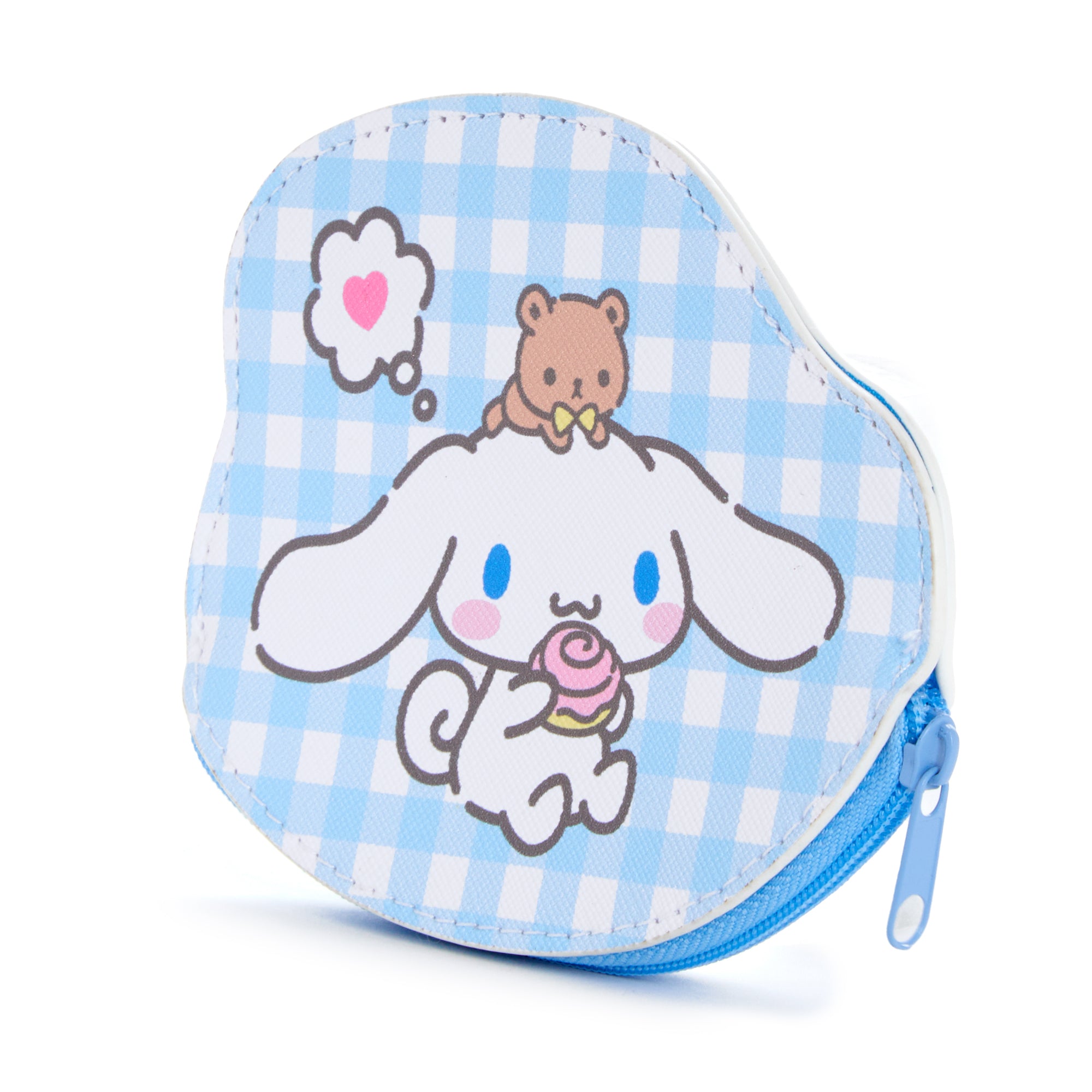 Cinnamoroll merchandise styled next to travel accessories on a desk