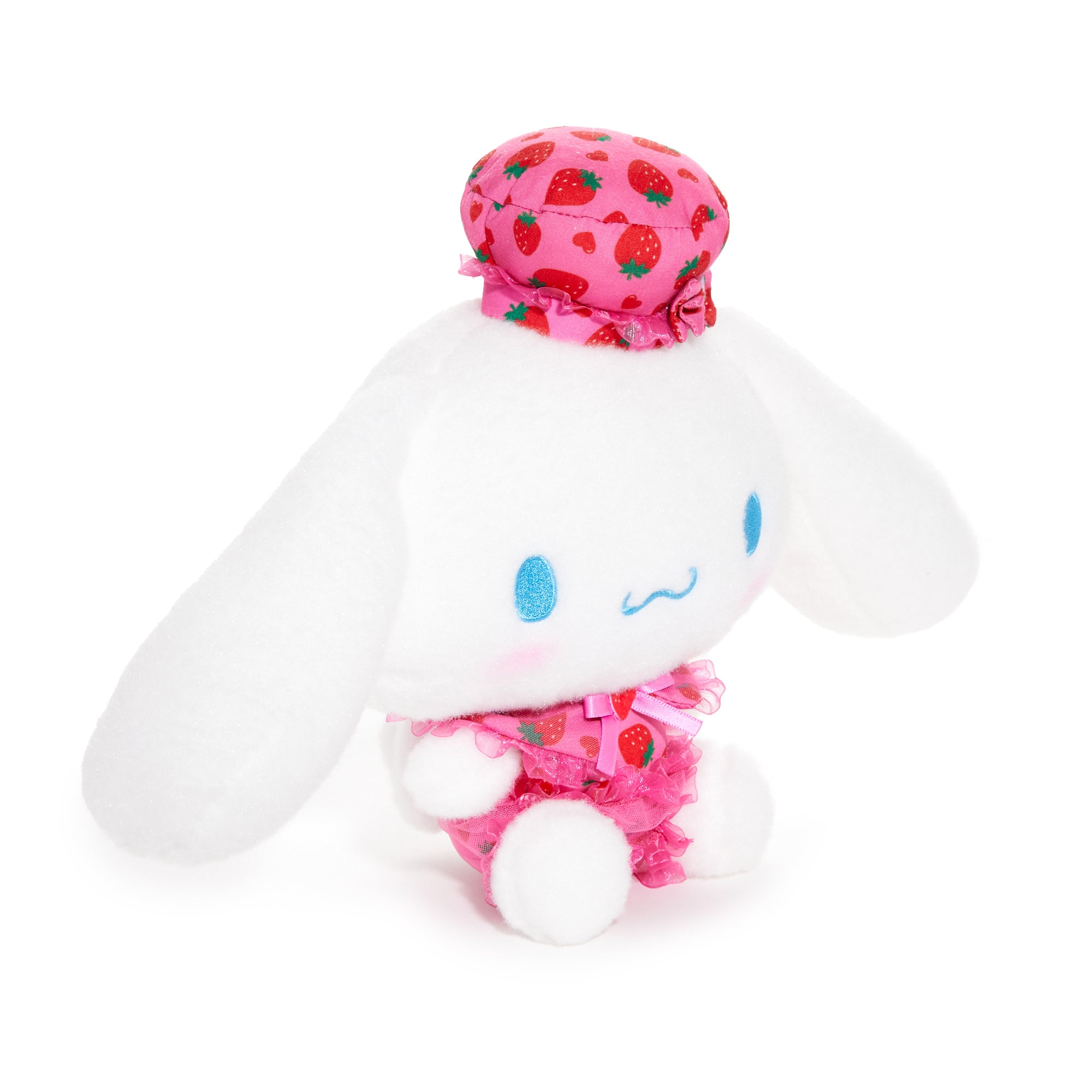 Cinnamoroll plush with strawberry outfit sitting on a shelf