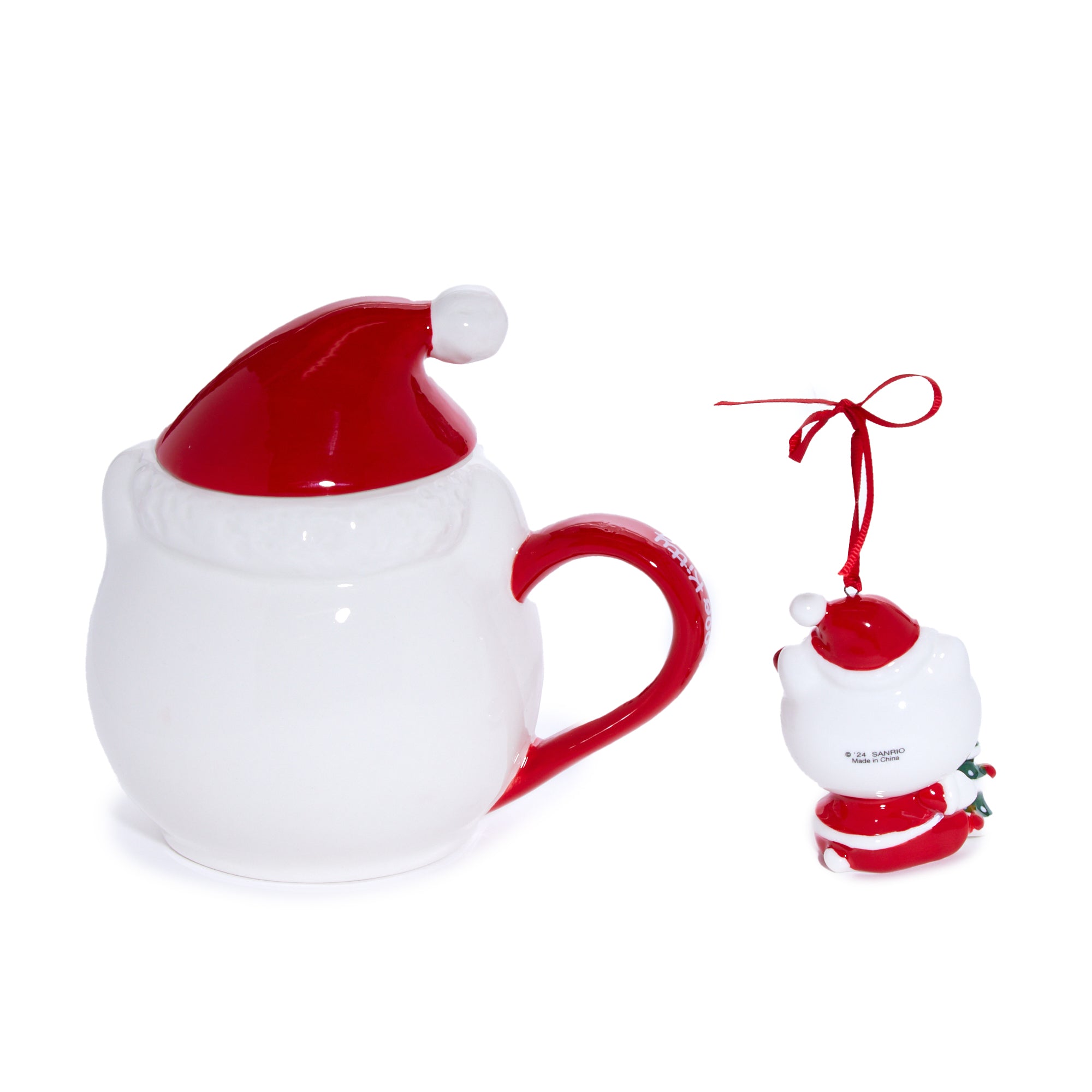 Close-up of Hello Kitty ceramic mug with red Santa bow and cheerful expression