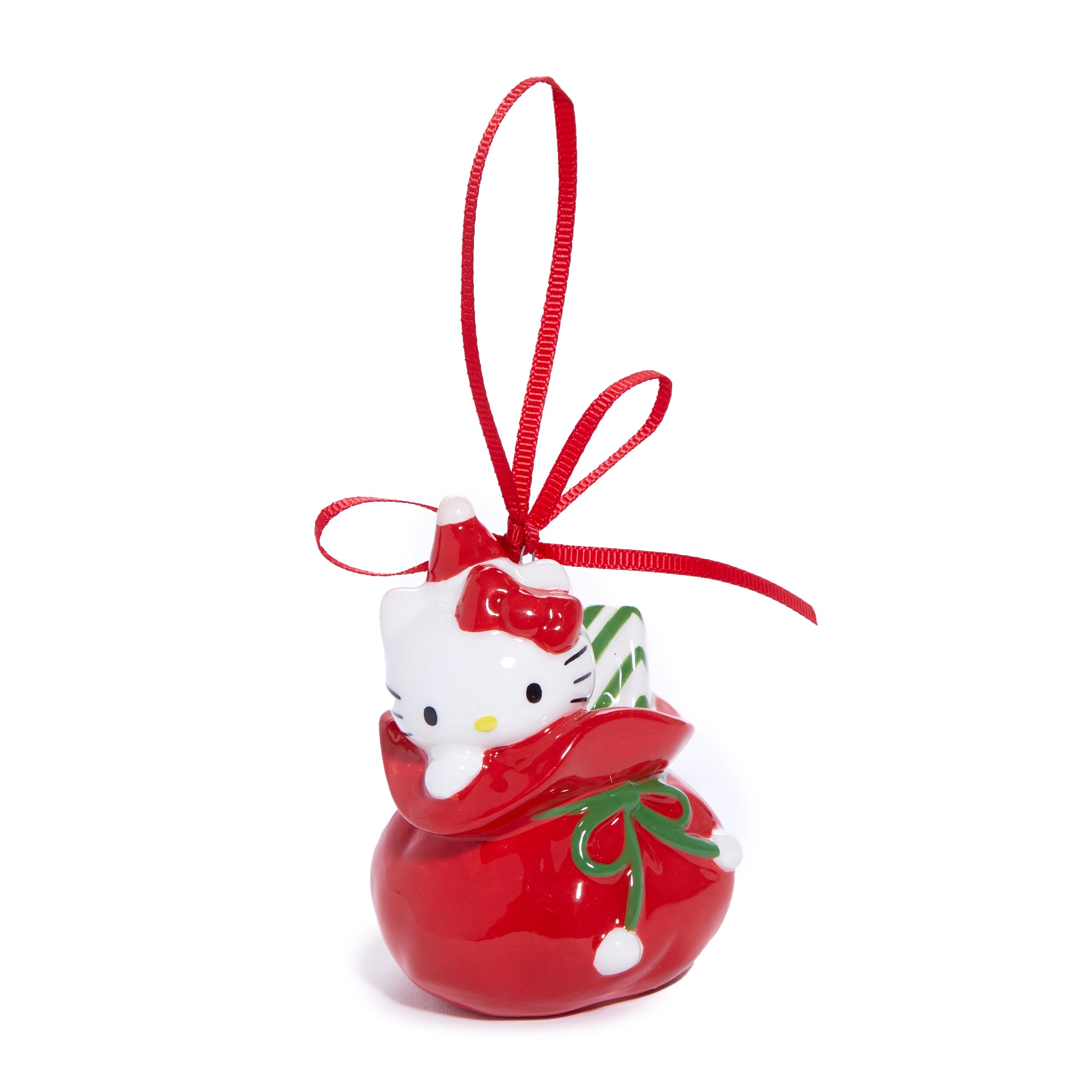 Front view of Hello Kitty ornament in red holiday outfit, hanging from a pine tree.